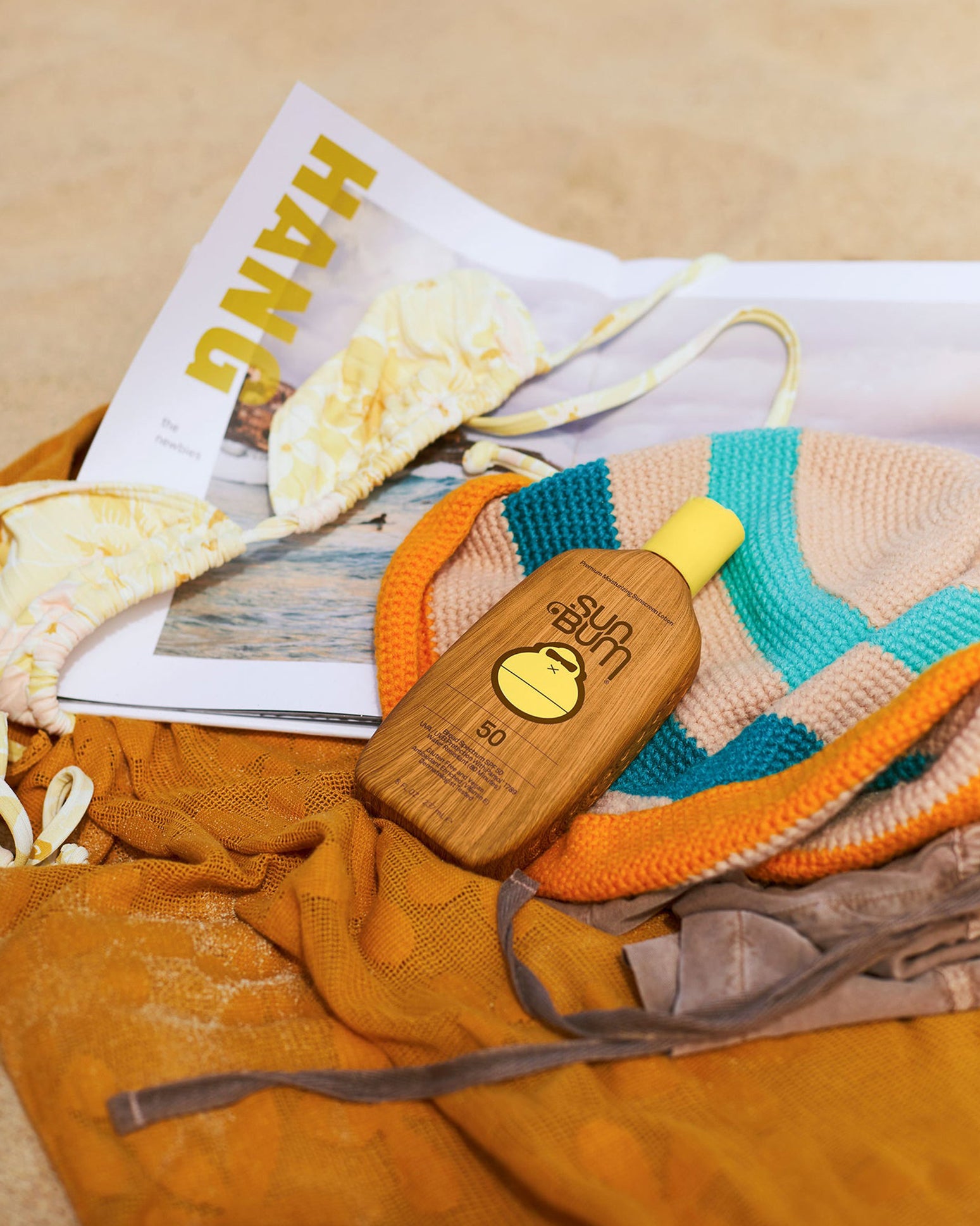 Sun Bum Original SPF 50 sunscreen lotion product image front view on a beach towel.