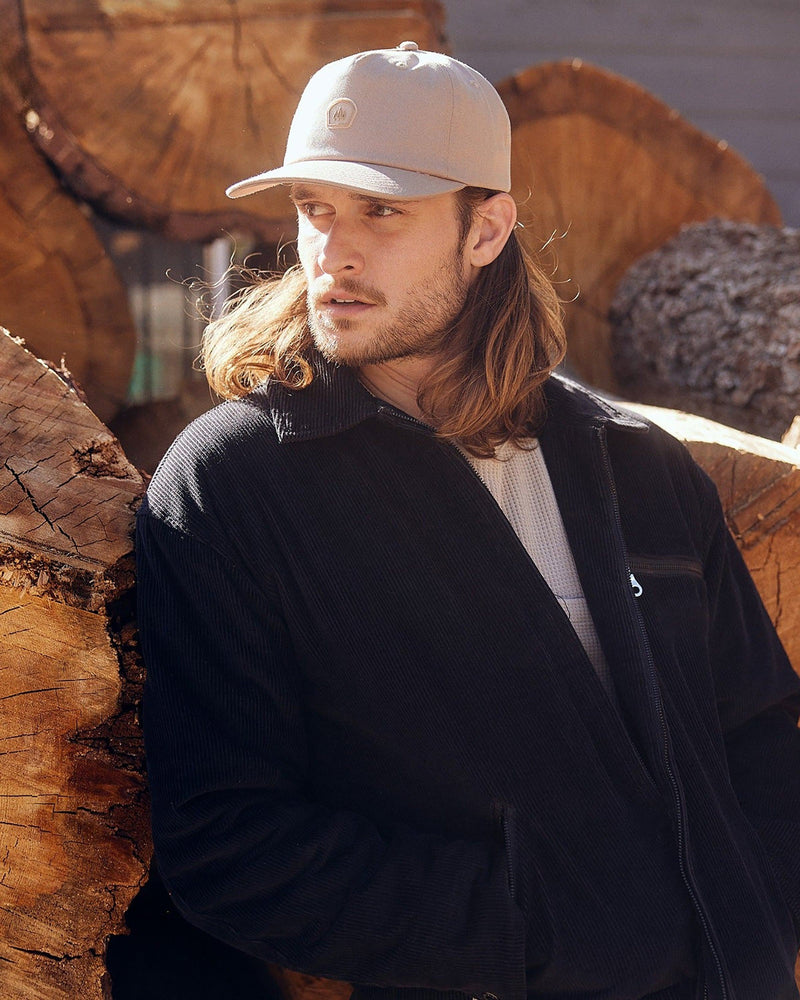 Hemlock male model looking left wearing Asher Baseball Hat in Khaki