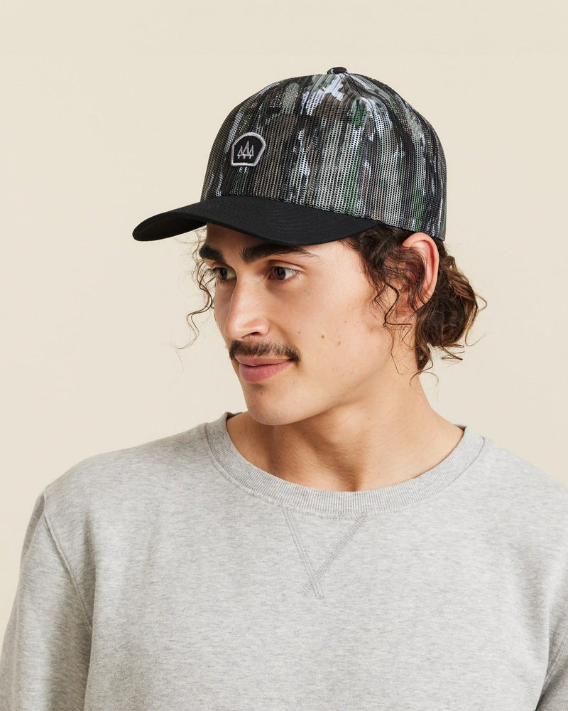Hemlock male model looking left wearing Backcountry Realtree® Trucker Hat