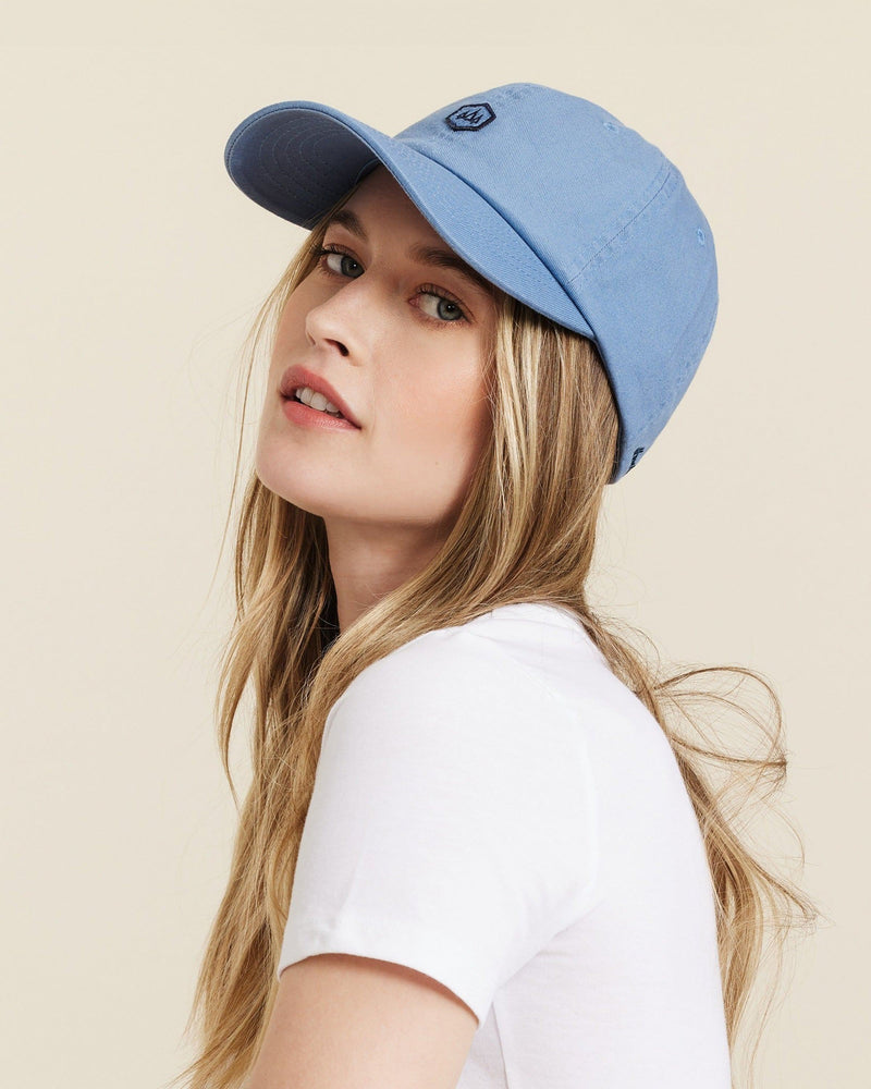 Hemlock female model looking over her shoulder wearing Berkley Dad Hat in Dusty Blue