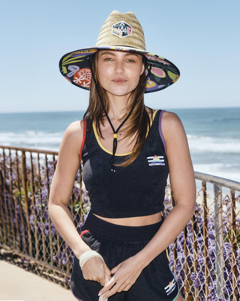 Hemlock female model looking straight wearing Blend straw lifeguard hat with Fruit pattern