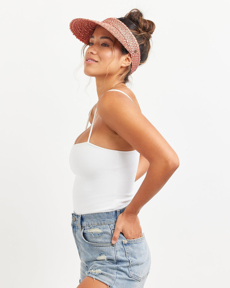 Hemlock female model looking left wearing Capri Straw visor in Rose