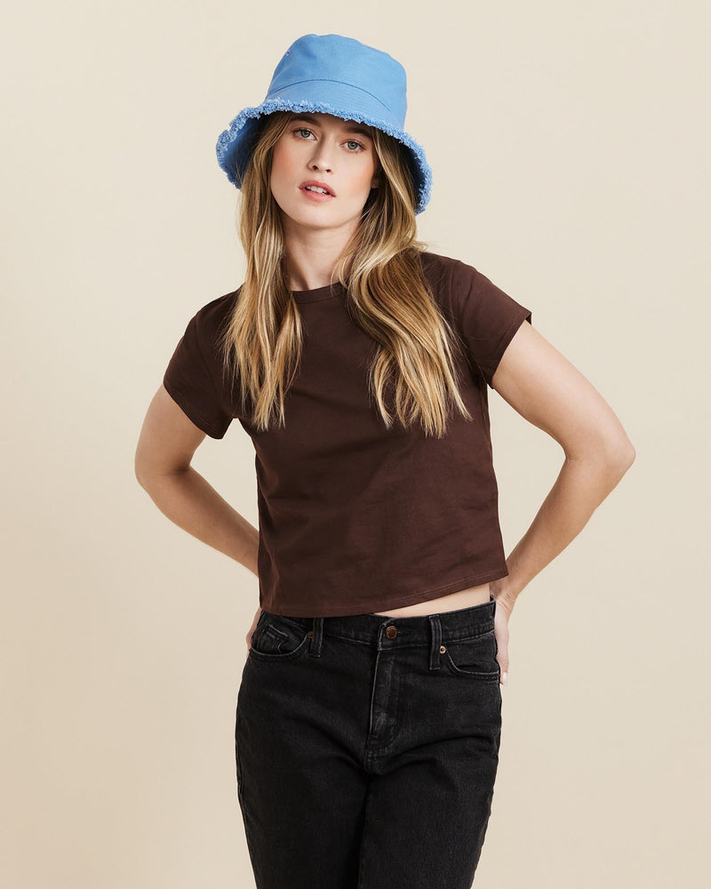 Hemlock female model looking straight wearing Coronado Cotton Bucket Hat in Faded Denim