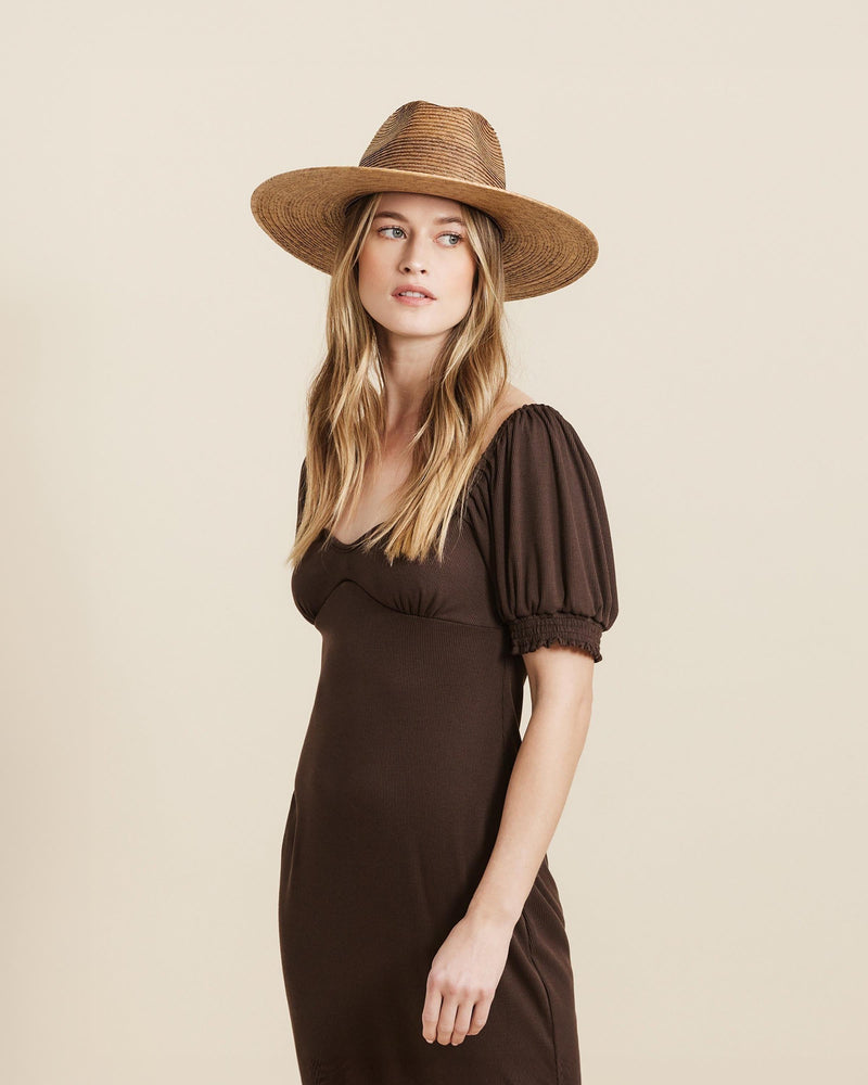 Hemlock female model looking right wearing Madero Straw Fedora in Toast color