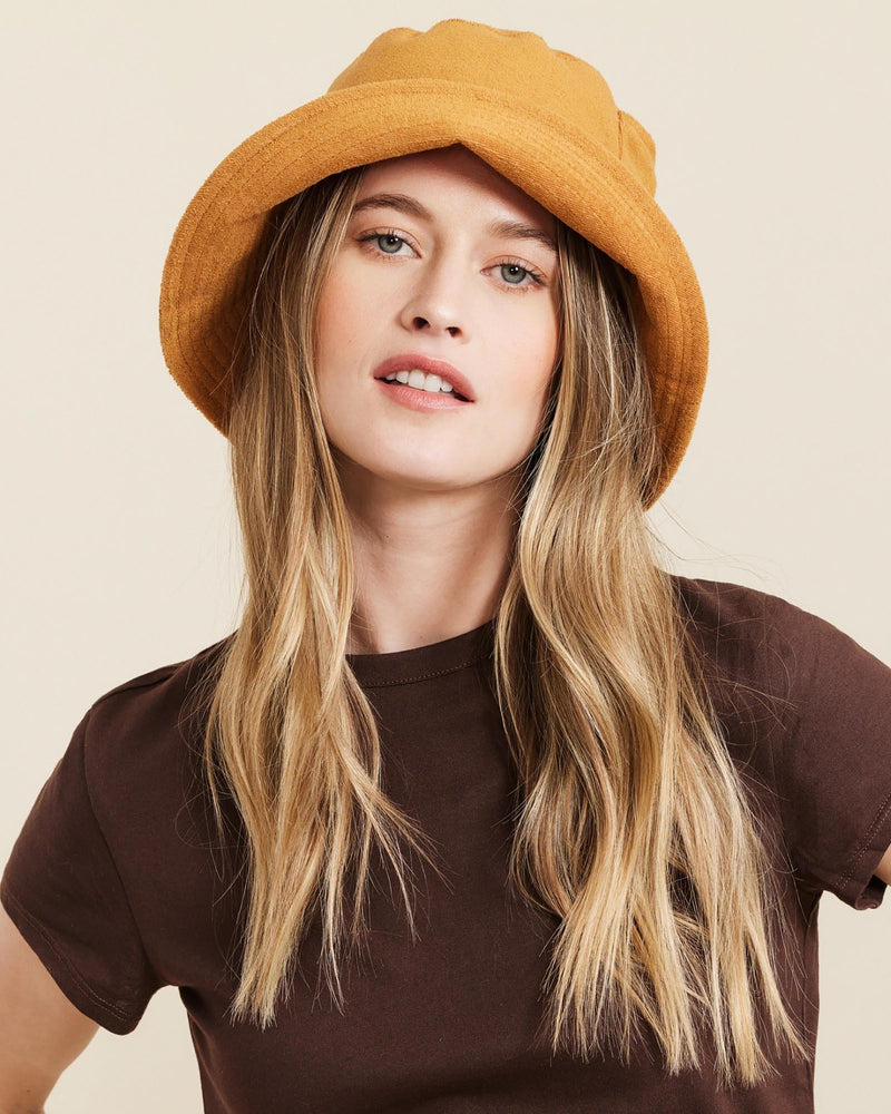 Hemlock female model looking straight wearing Marina Terry Bucket Hat in Dijon