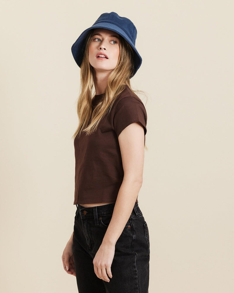 Hemlock female model looking up wearing Marina Terry Bucket Hat in Indigo