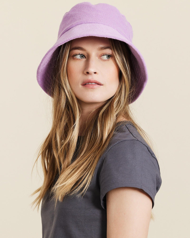 Hemlock female model wearing Marina Terry Bucket Hat in Lilac close up