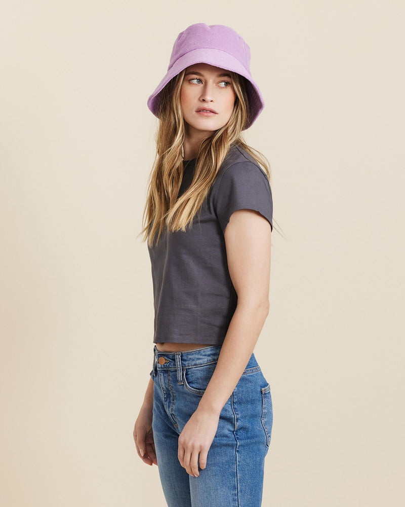 Hemlock female model looking right wearing Marina Terry Bucket Hat in Lilac