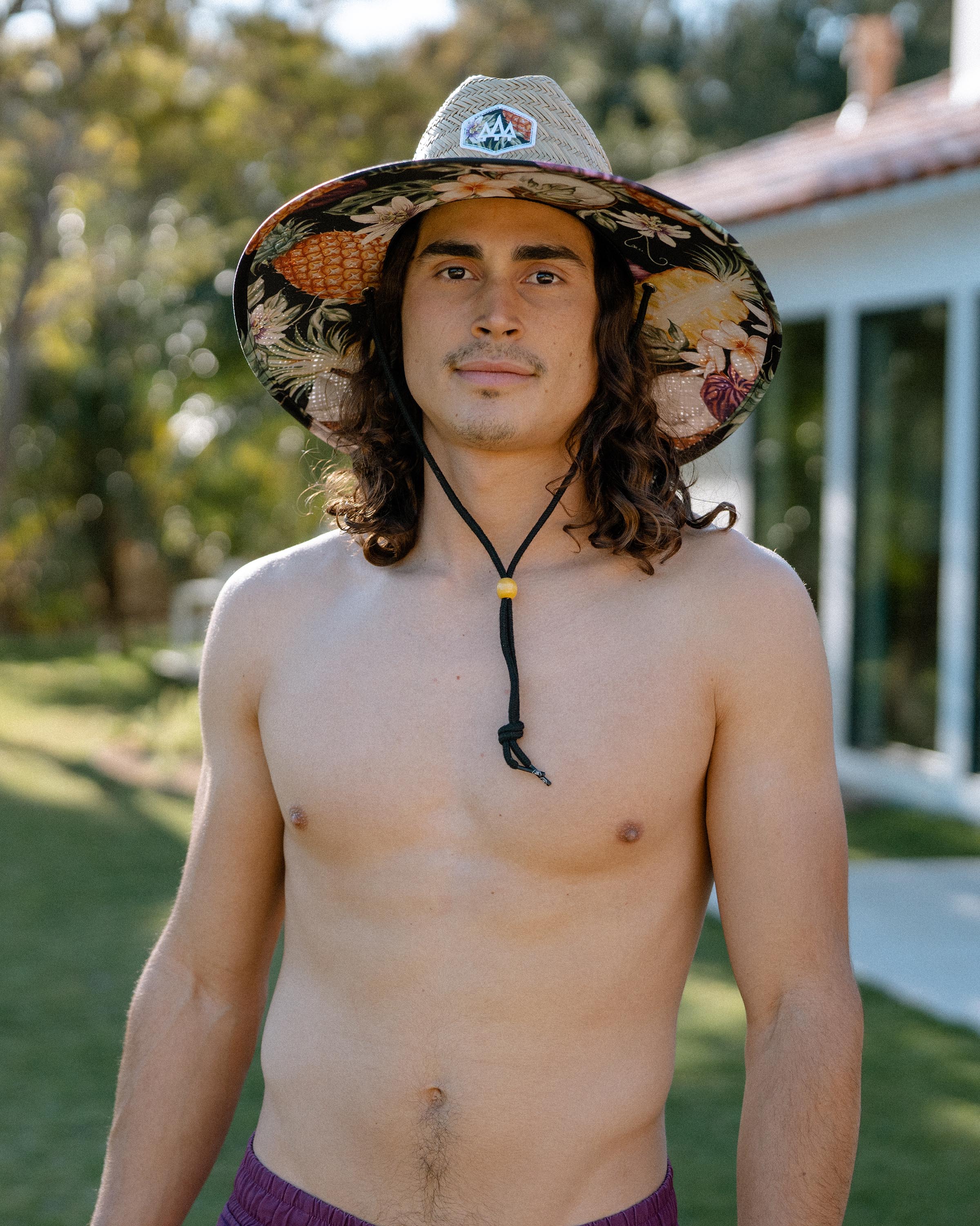 Hemlock male model looking straight wearing Nightcap straw lifeguard hat with pineapple pattern