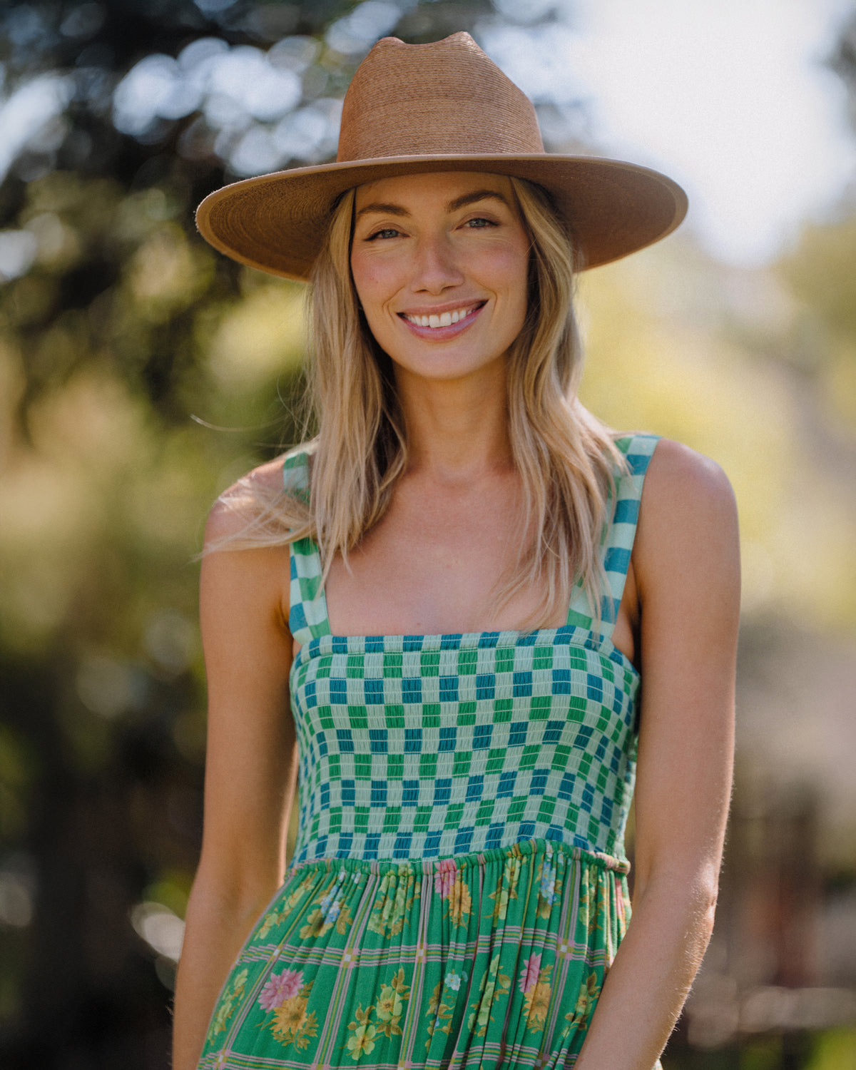 Hemlock female model wearing the Toluca Rancher Straw Hat in Saddle smiling 