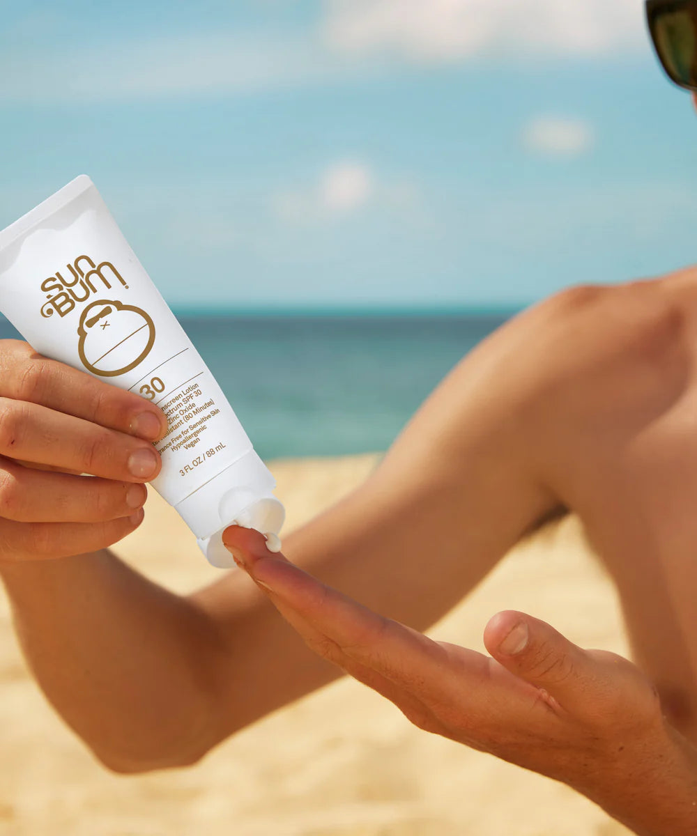 model applying the Sun Bum® Mineral SPF 30 Sunscreen Lotion