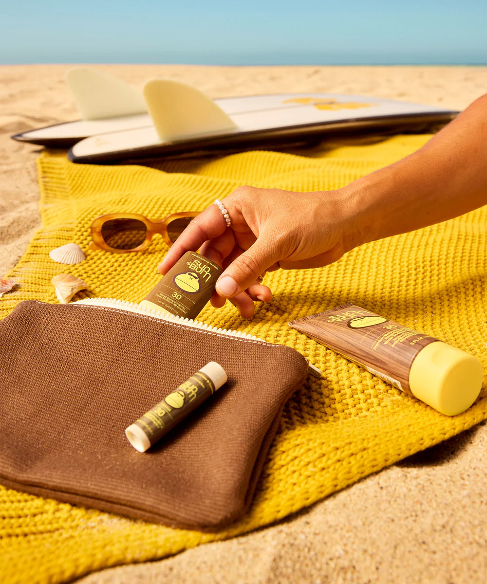 girl grabbing items from the Sun Bum® Road Tripper Kit