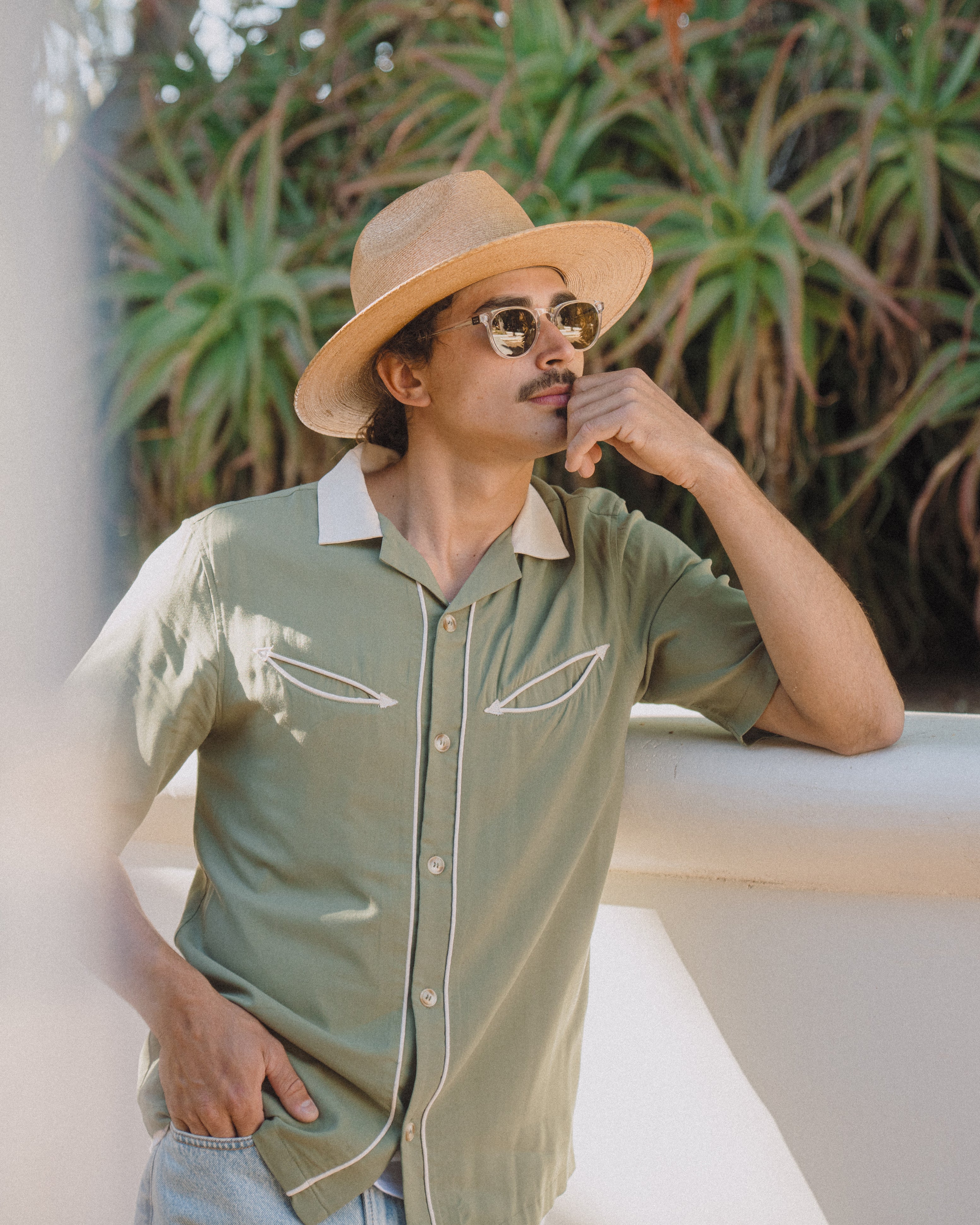 Hemlock male model wearing the Botero Fedora Straw Hat thinking