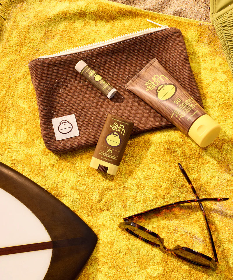 Sun Bum® Road Tripper Kit laying on top of beach towel