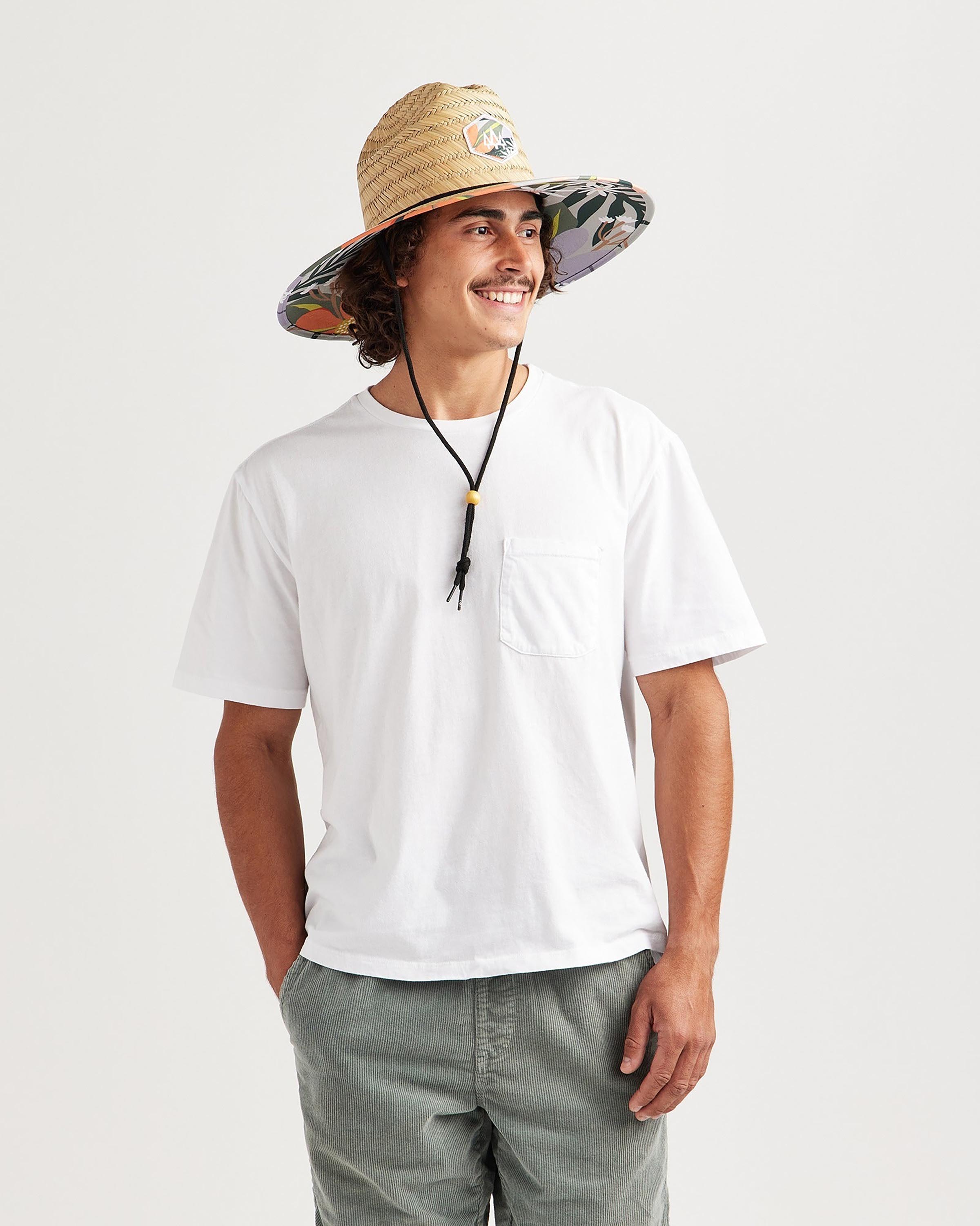 Hemlock male model looking left wearing Barbados straw lifeguard hat with orange floral print