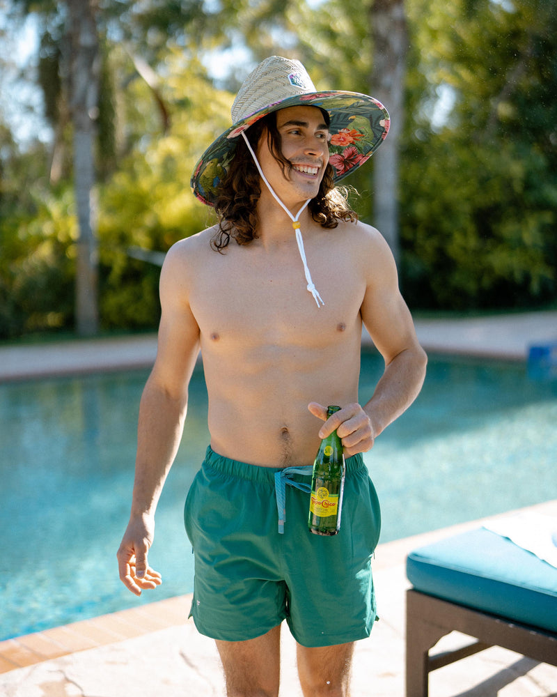 Hemlock male model looking right wearing Caicos straw lifeguard hat with green parrot pattern