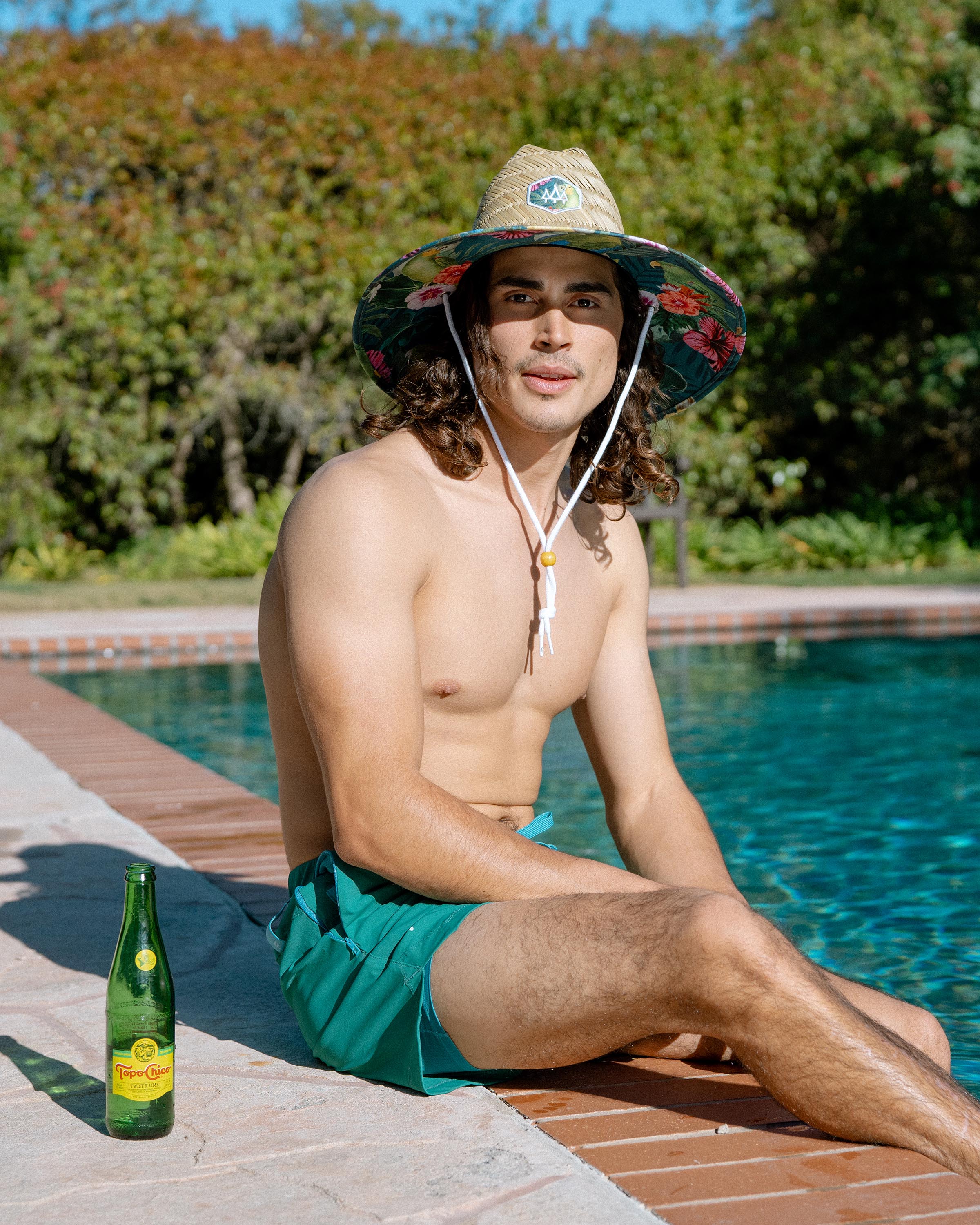 Hemlock male model looking straight wearing Caicos straw lifeguard hat with green parrot pattern