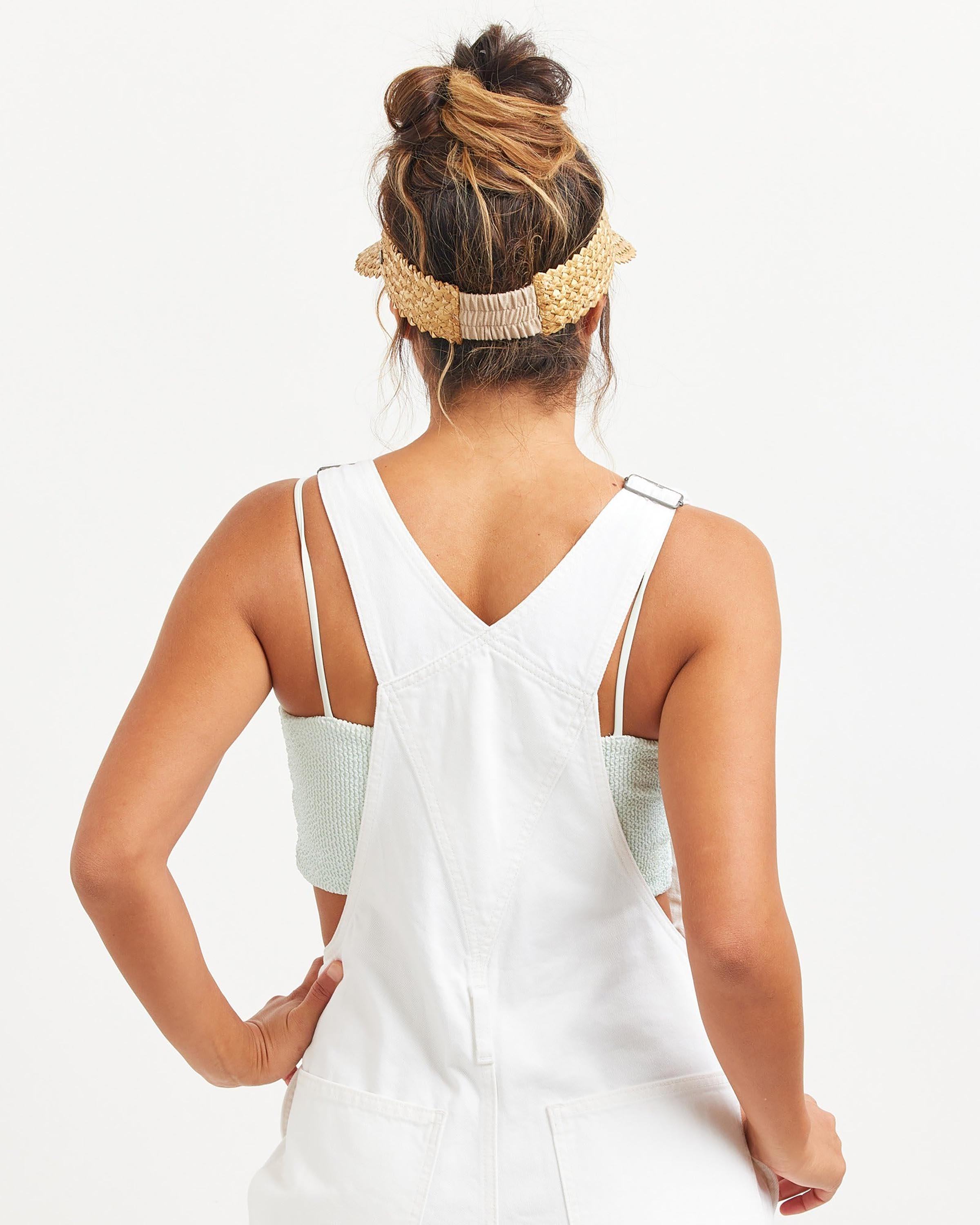 Hemlock female model wearing Capri Straw visor in Honeycomb back view