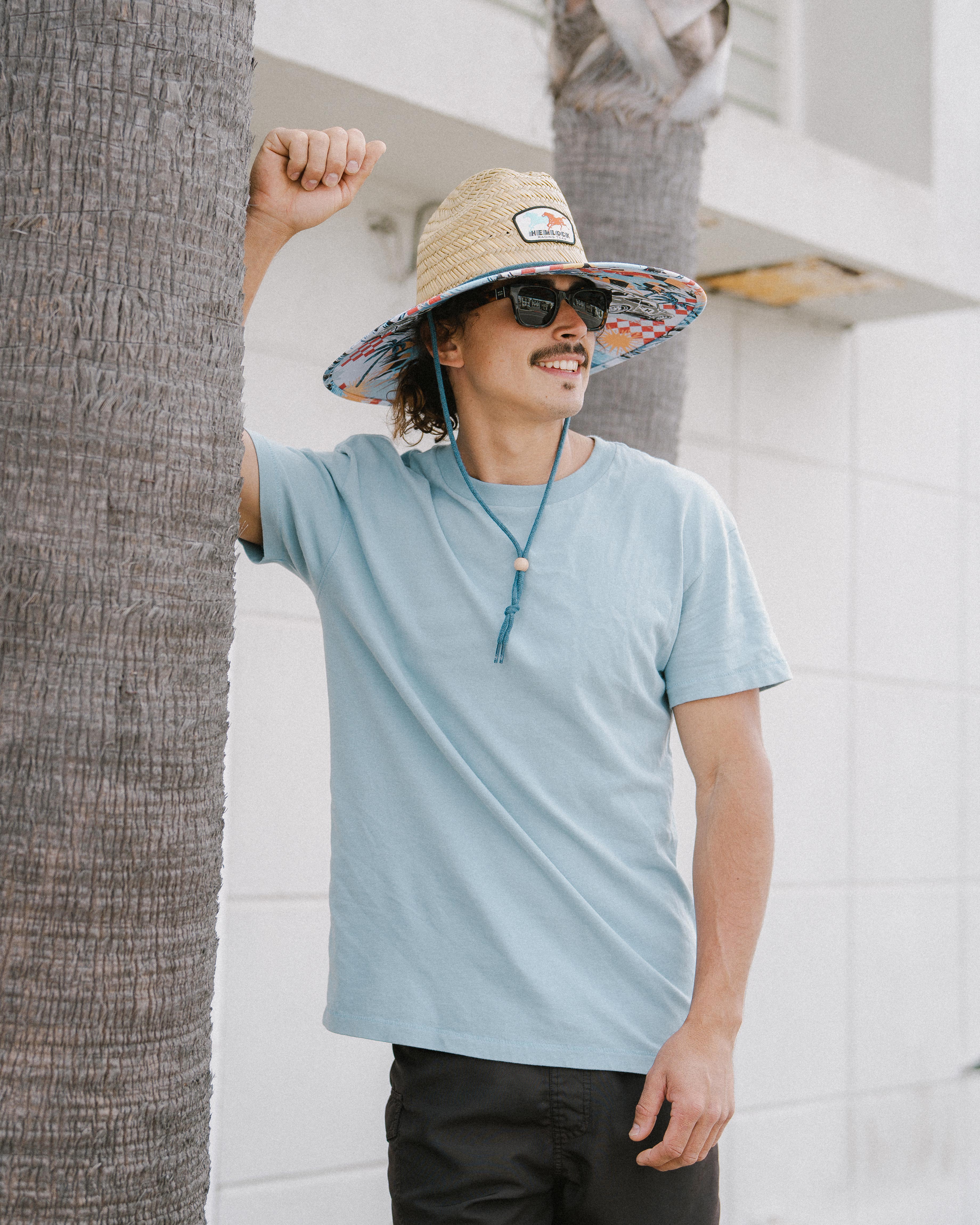 Hemlock male Model wearing the
UPF50+ Lifeguard hat in Racing Legend
print looking to the side