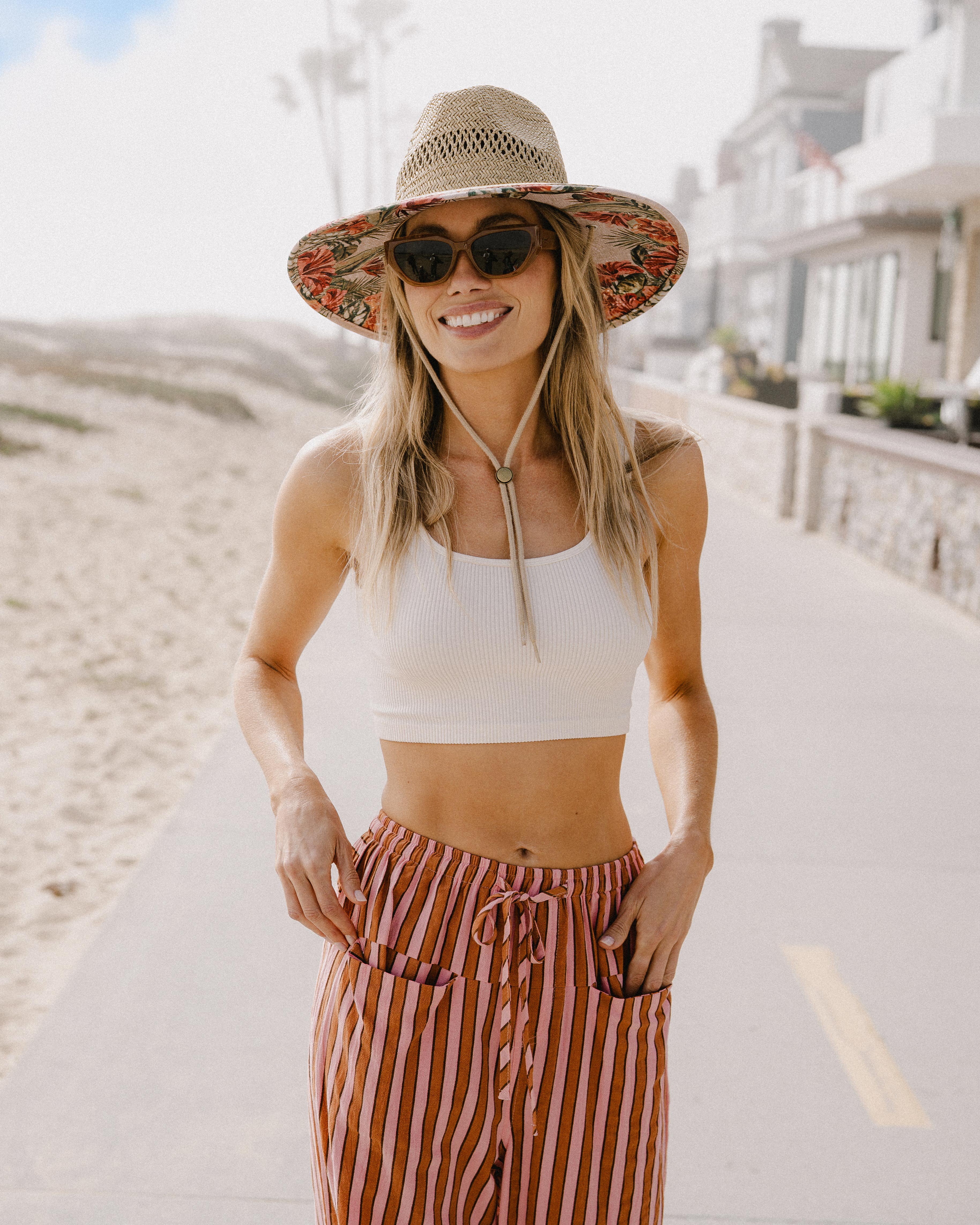 Hemlock female Model wearing the
UPF50+ Lifeguard hat in Hibiscus
print smiling