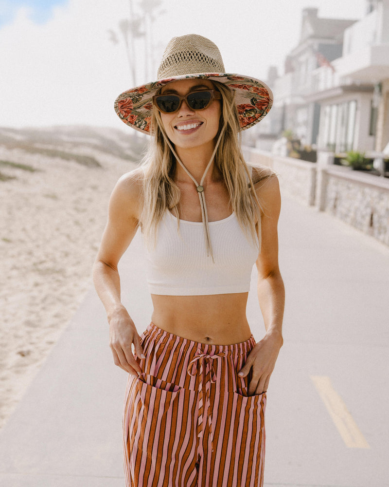 Hemlock female Model wearing the
UPF50+ Lifeguard hat in Hibiscus
print smiling