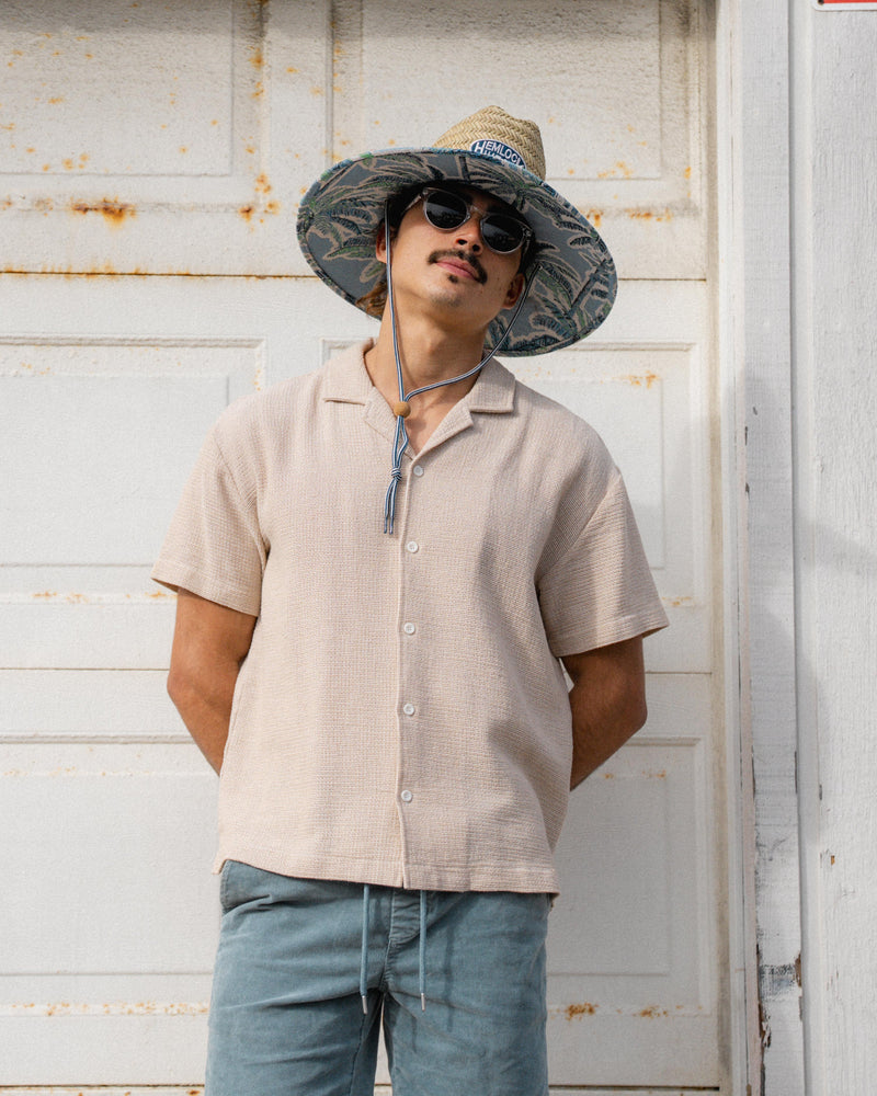 Hemlock male Model wearing the
UPF50+ Lifeguard hat in Jacquard Palms
print