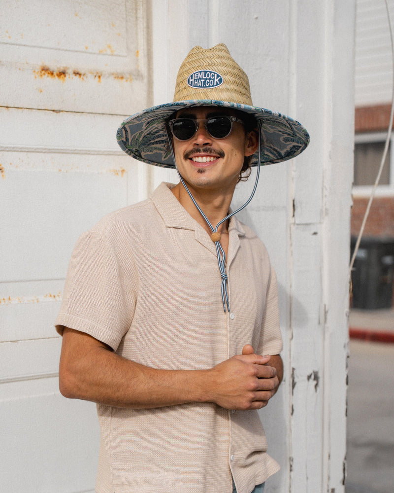 Hemlock male Model wearing the
UPF50+ Lifeguard hat in Jacquard Palms
print smiling