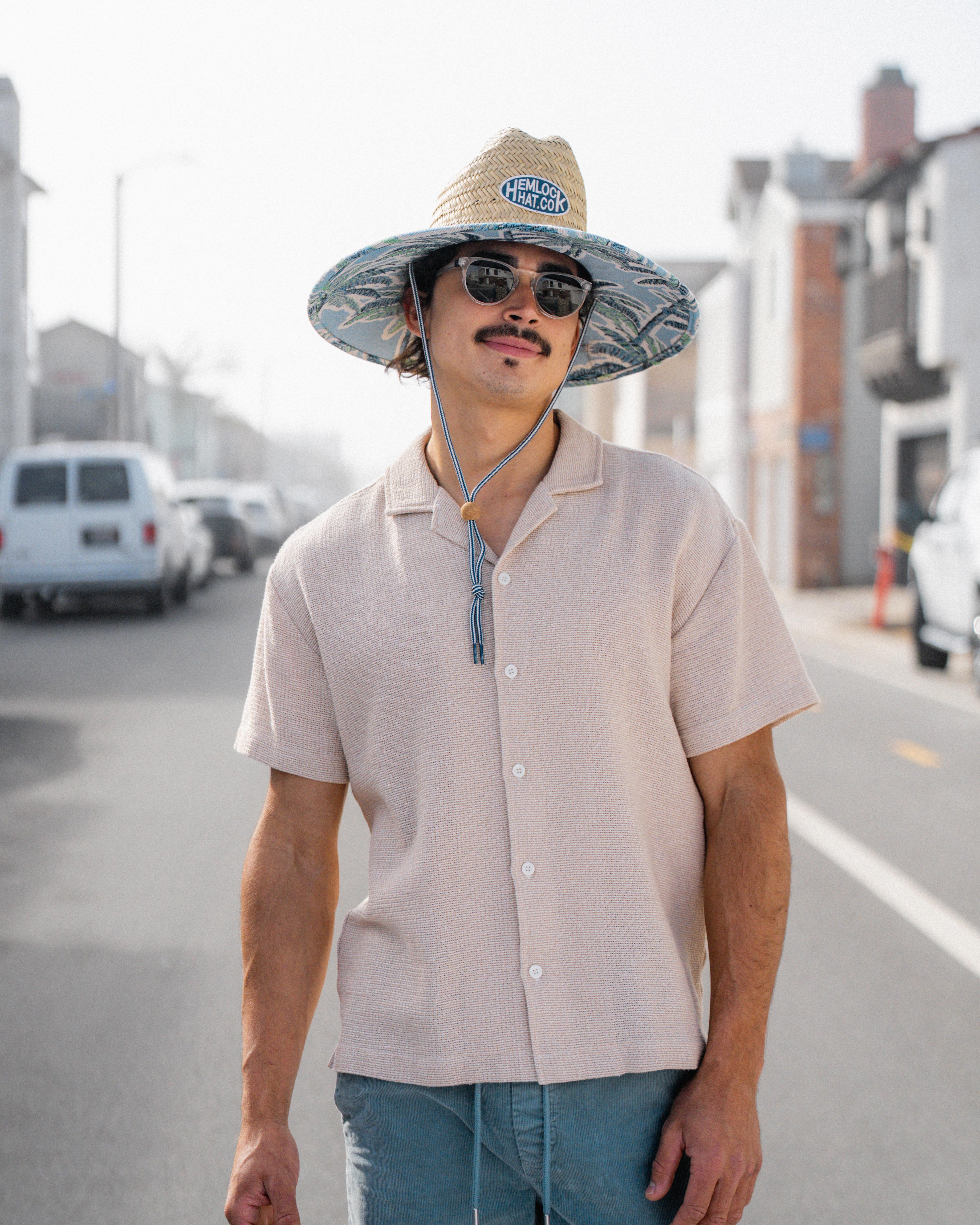 Hemlock female Model wearing the
UPF50+ Lifeguard hat in Jacquard Palms
print looking right