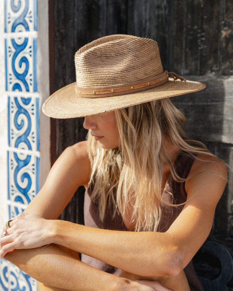Hemlock female model wearing the Madero Fedora with a brown leather band
in brown close up
