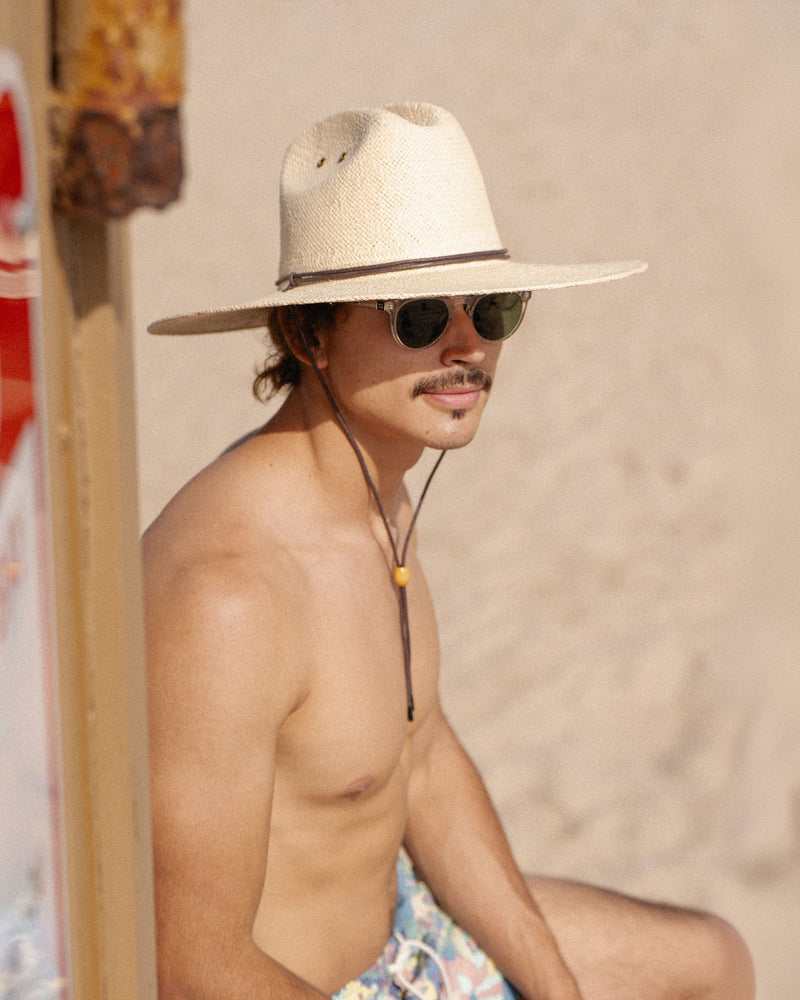 Hemlock male model wearing the Las Olas packable lifeguard in white sand