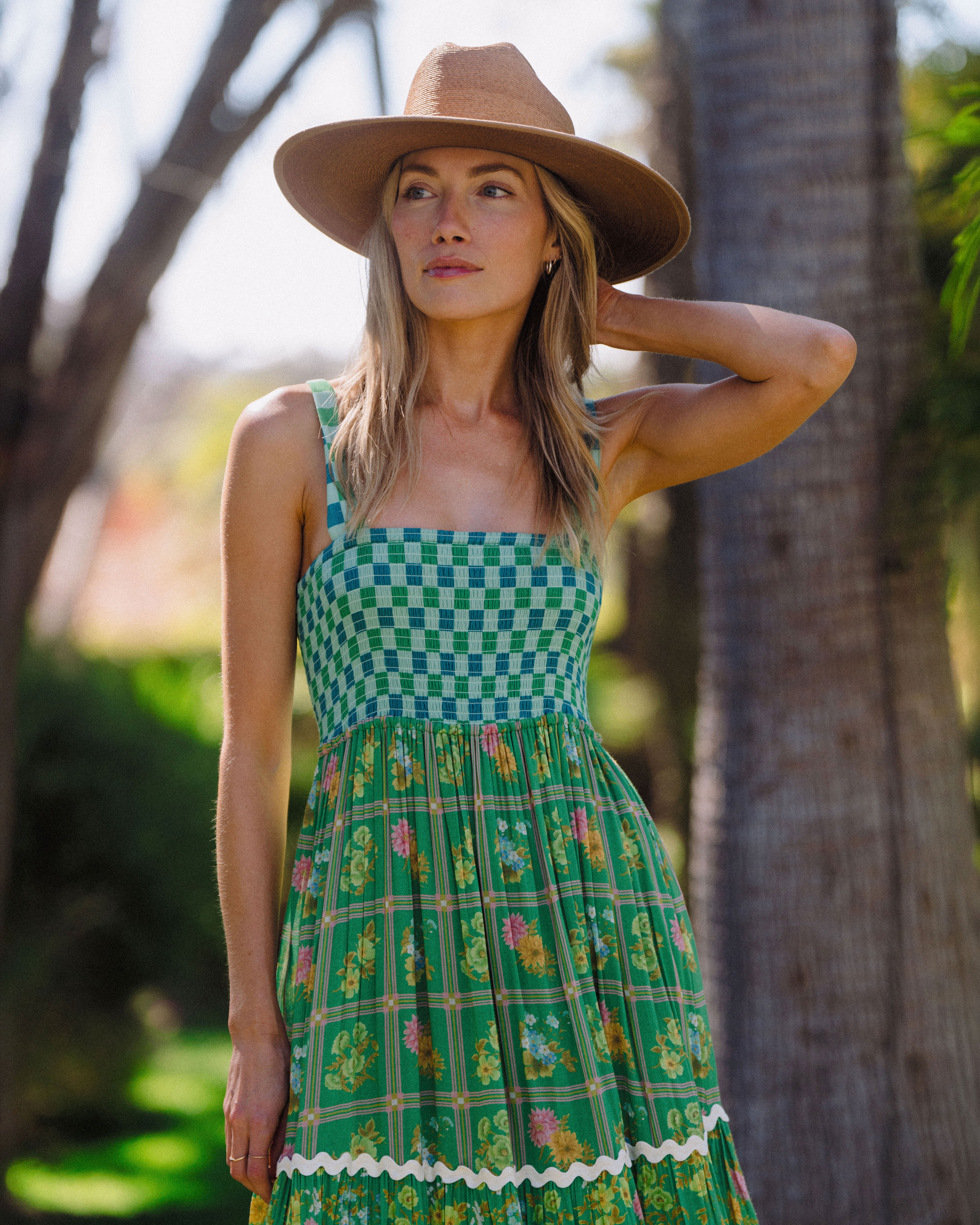Hemlock female model wearing the Toluca Rancher Straw Hat in Saddle smiling serious