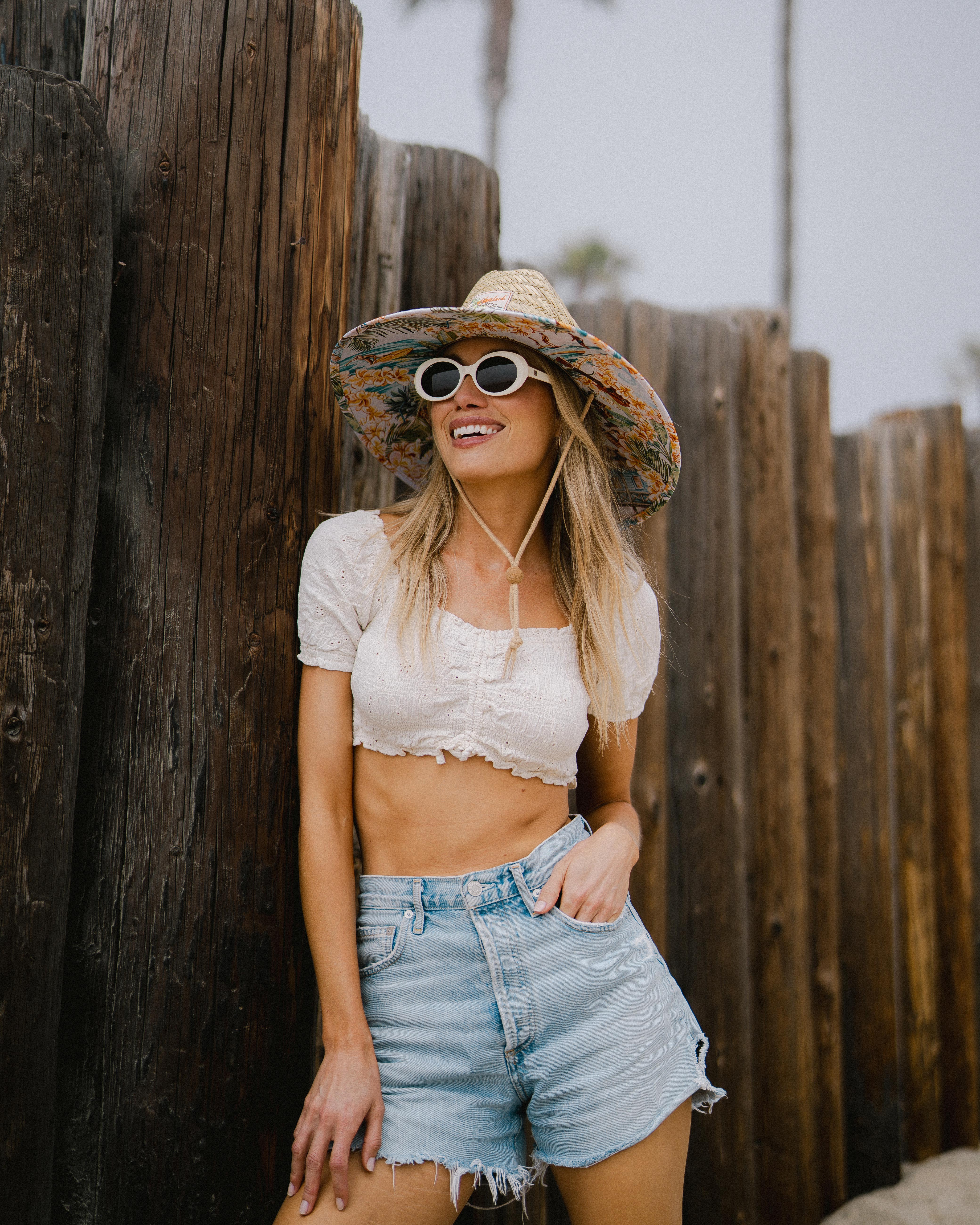 Hemlock female Model wearing the
UPF50+ Lifeguard hat in Aloha tropics
print smiling
