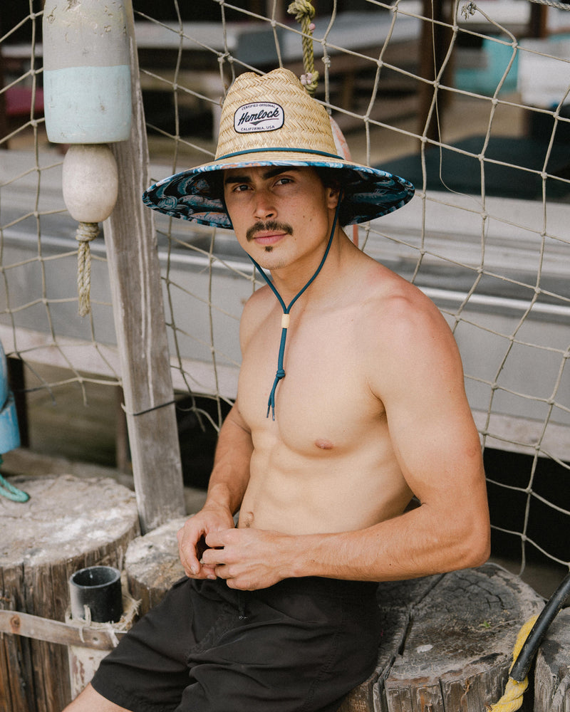 Hemlock male Model wearing the
UPF50+ Lifeguard hat in Blue Fish
print looking at the camera