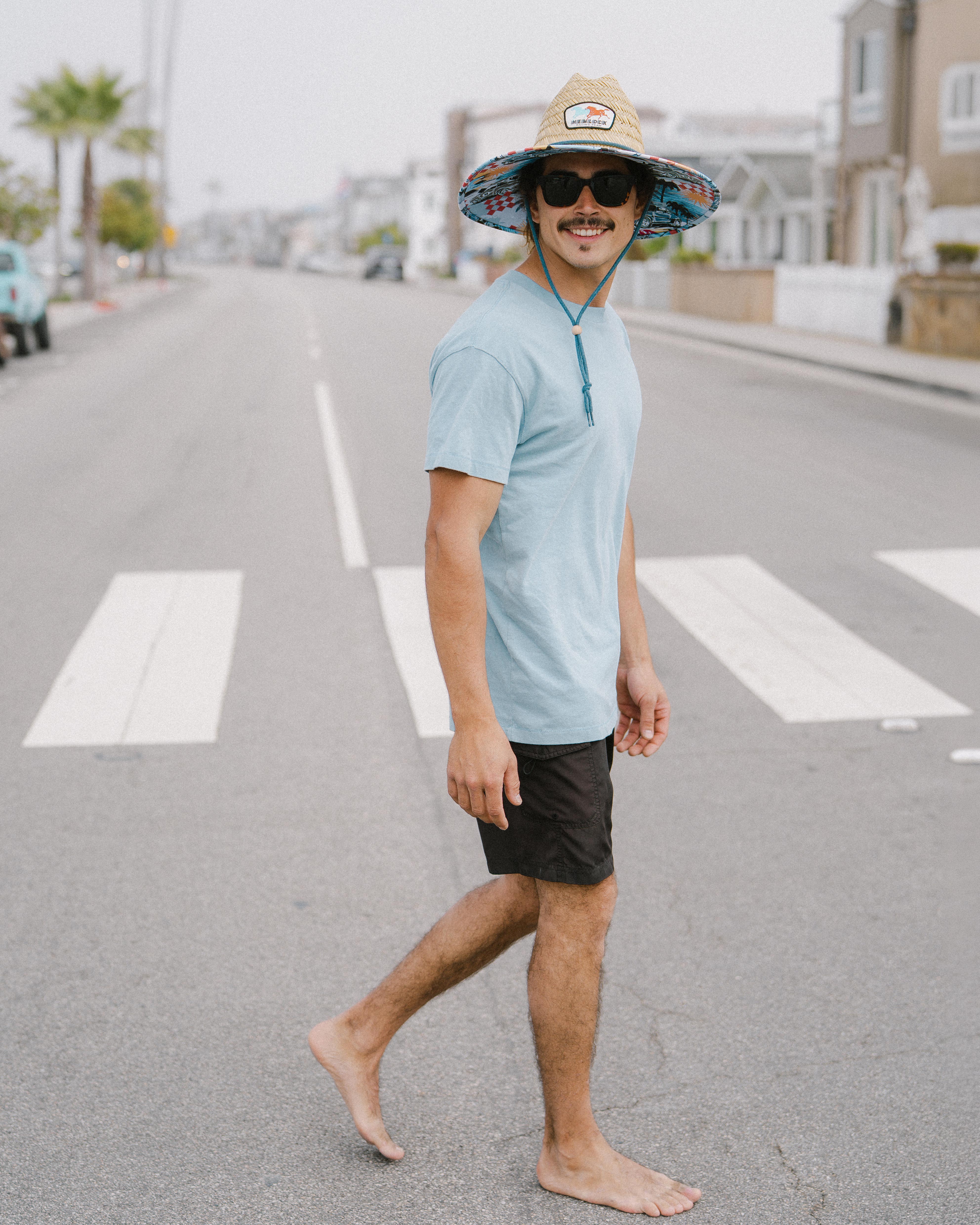 Hemlock male Model wearing the
UPF50+ Lifeguard hat in Racing Legend
print smiling 