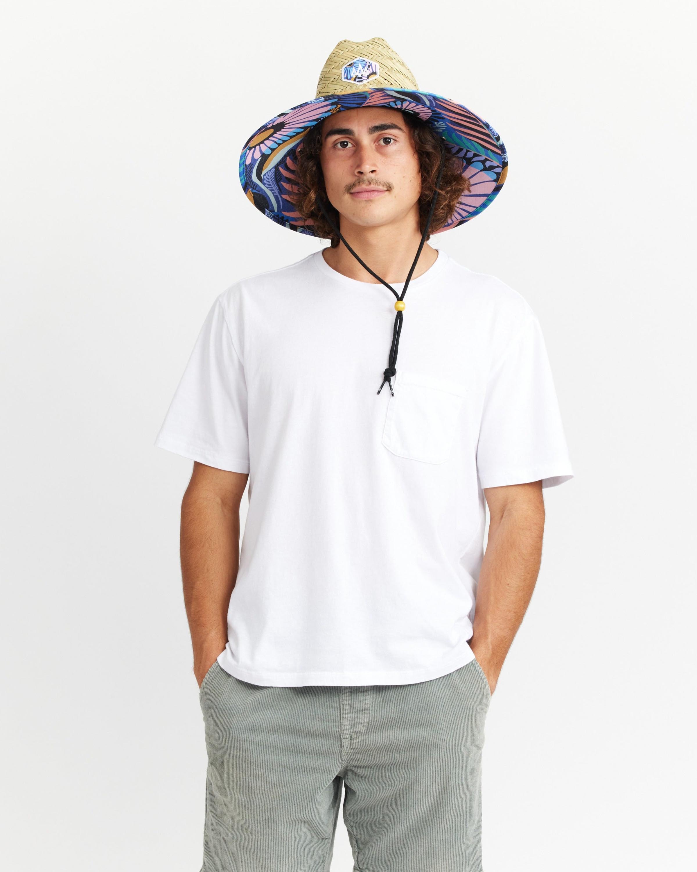 Hemlock male model looking straight wearing Eden straw lifeguard hat with purple floral pattern