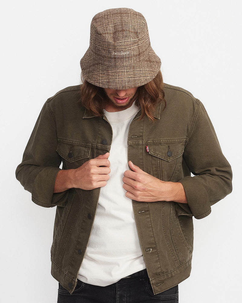  Hemlock male model looking down wearing Gable Wool Bucket Hat in Brown and Tan