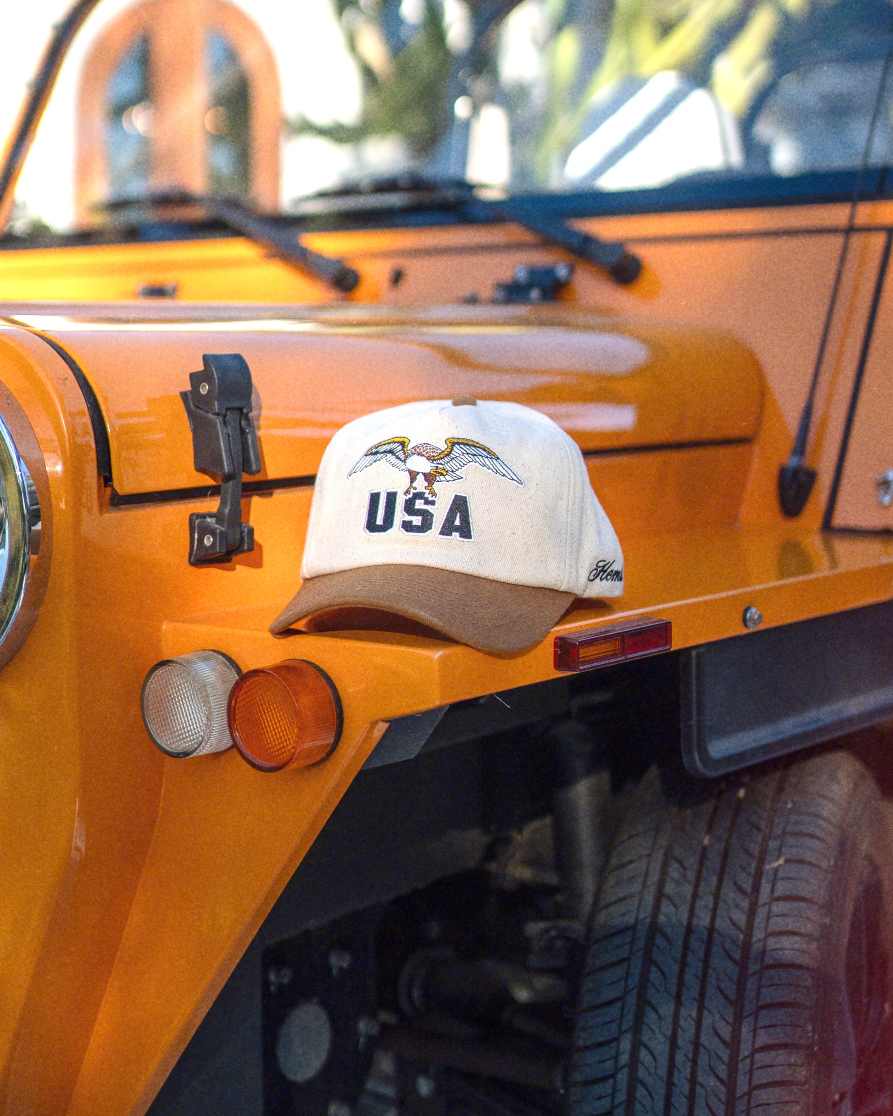 Hemlock USA Baseball Hat in Brown on orange jeep