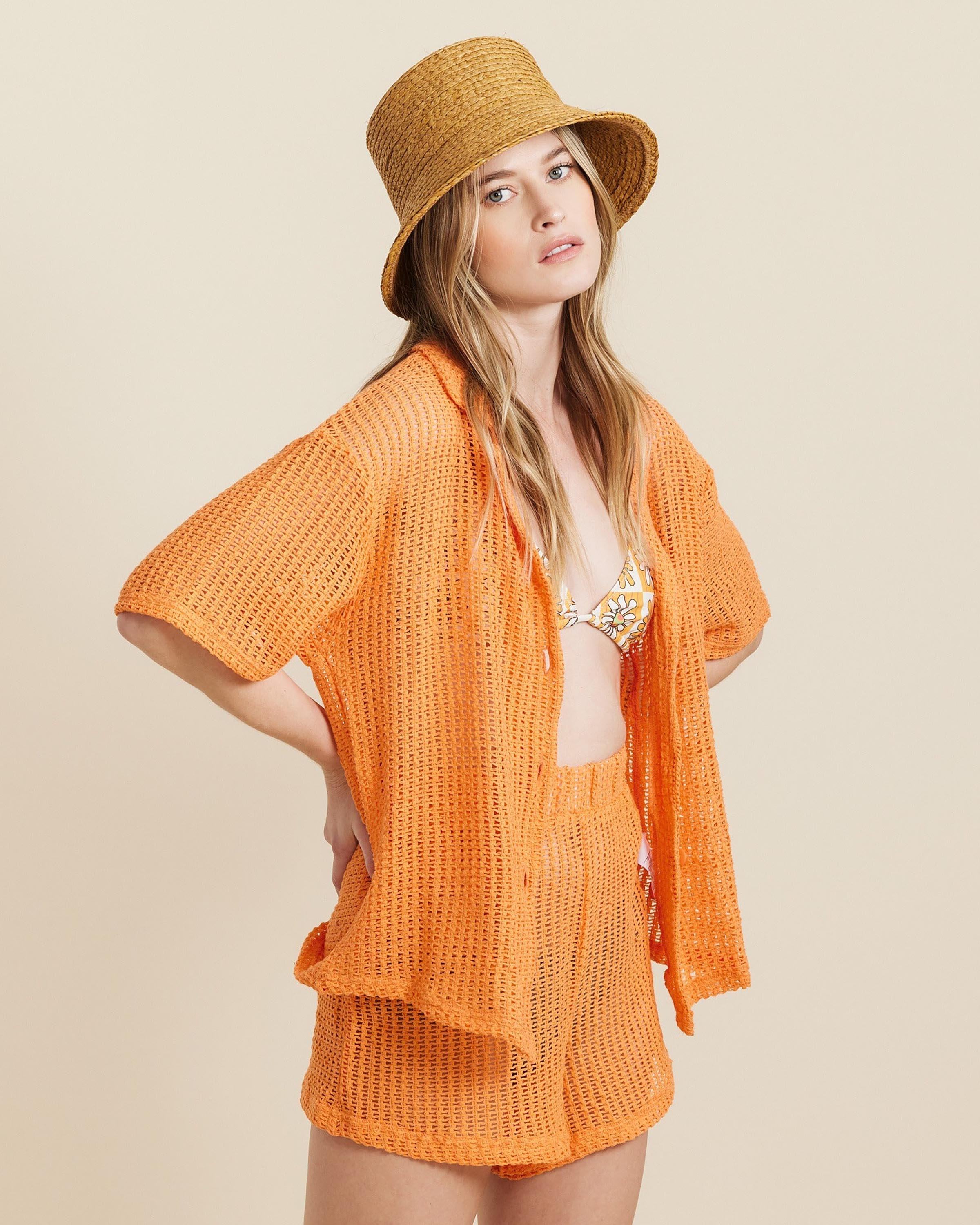 Hemlock female model looking over her shoulder wearing Haven Straw Bucket Hat in Fawn