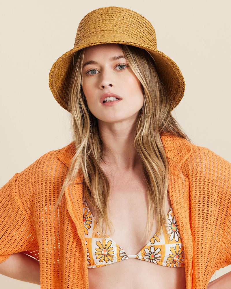 Hemlock female model looking straight wearing Haven Straw Bucket Hat in Fawn