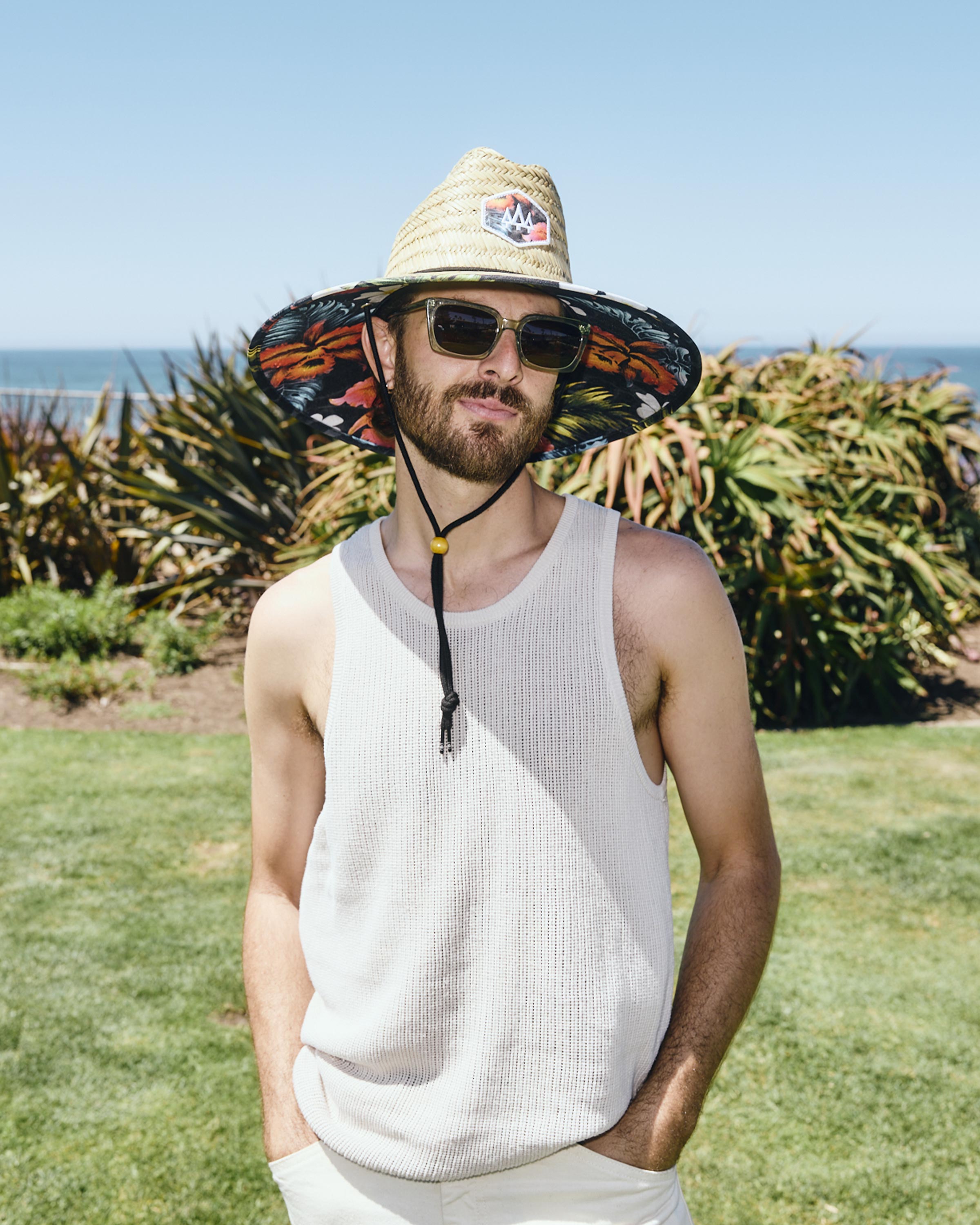 Hemlock male model wearing Kailua straw lifeguard hat with hawaiian floral pattern