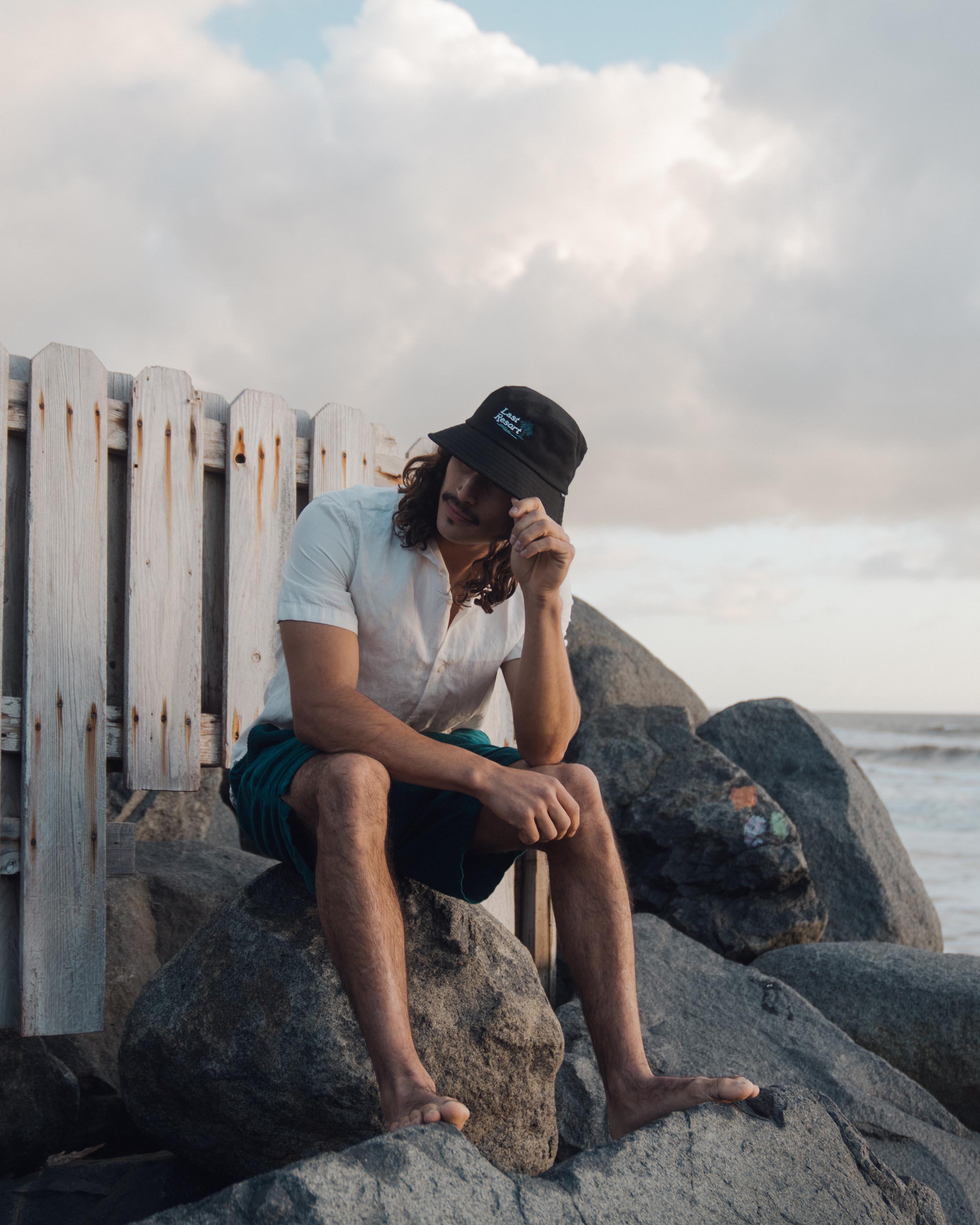 Hemlock male model looking left wearing Hemlock Last Resort Cotton Bucket Hat in Black