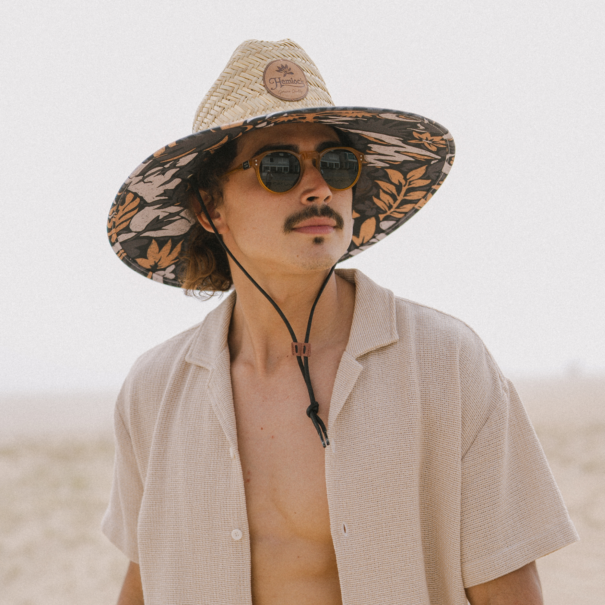 hemlock male model wearing the desert bloom lifeguard hat - featured lifeguard hat card