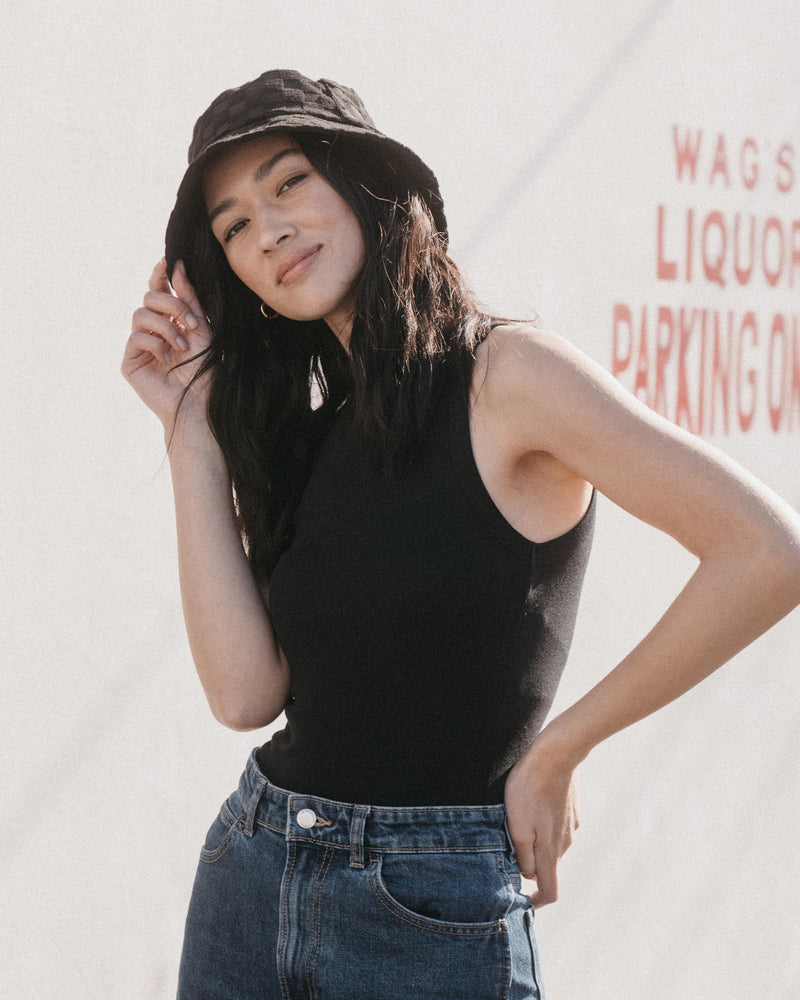 Hemlock female model looking straight wearing Marina Terry Bucket Hat in Black Check