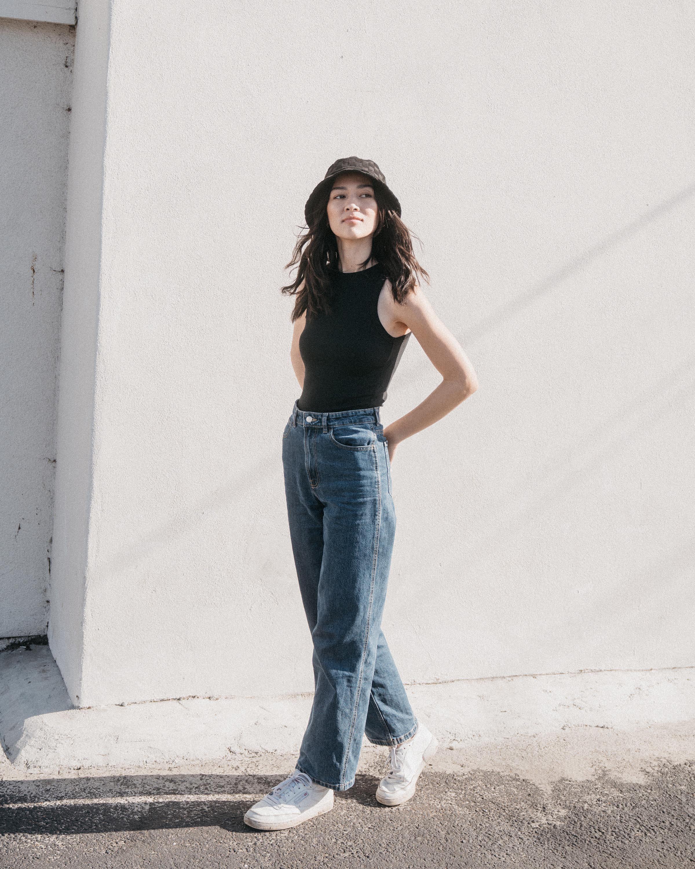 Hemlock female model looking right wearing Marina Terry Bucket Hat in Black Check