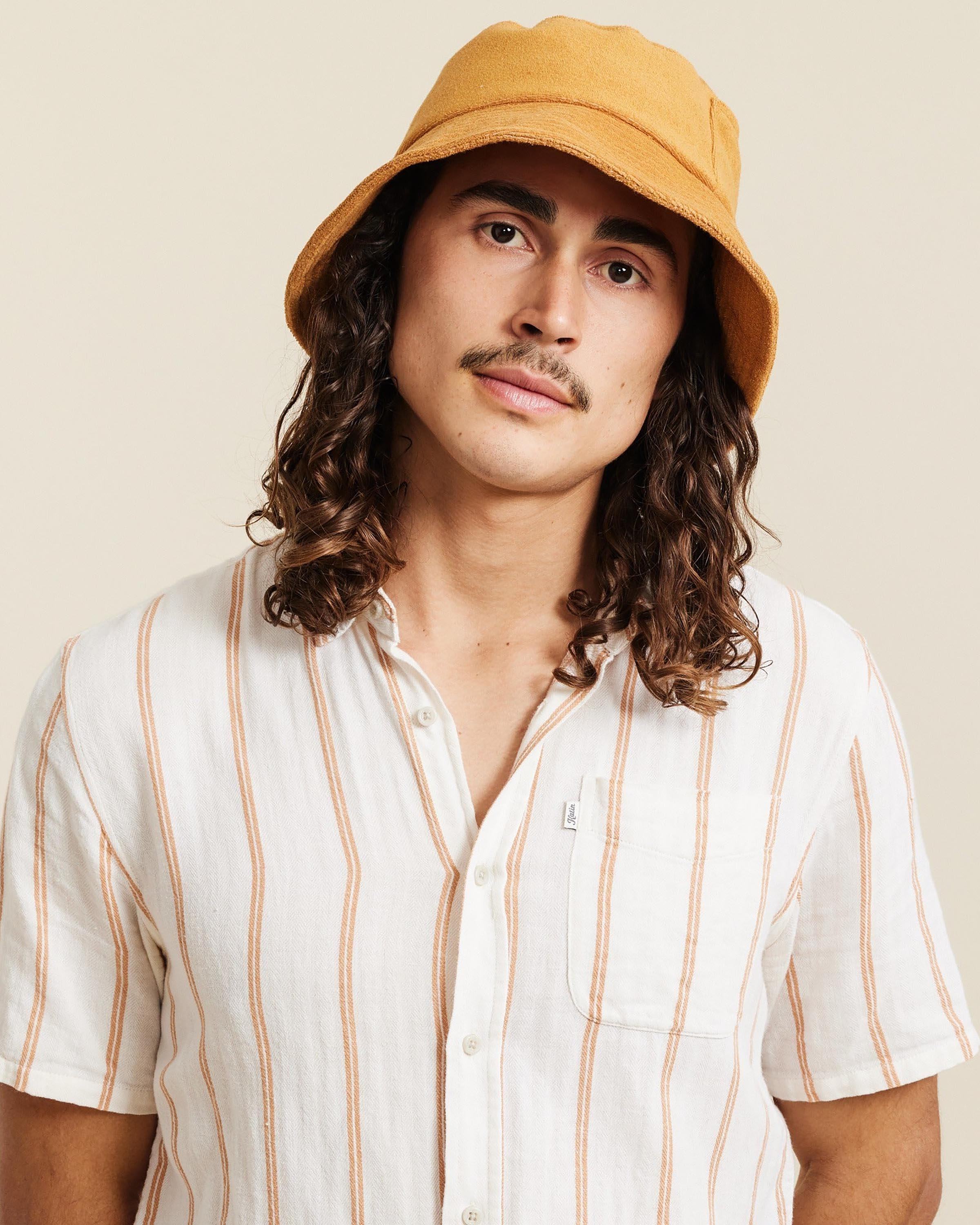 Hemlock male model looking straight wearing Marina Terry Bucket Hat in Dijon