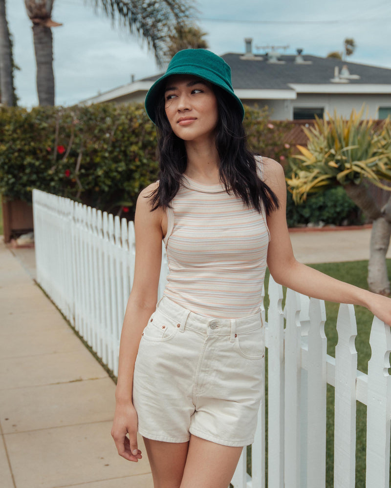 Hemlock female model looking left wearing Marina Terry Bucket Hat in Emerald