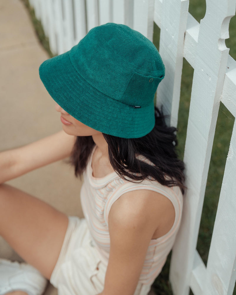 Hemlock female model wearing Marina Terry Bucket Hat in Emerald top view