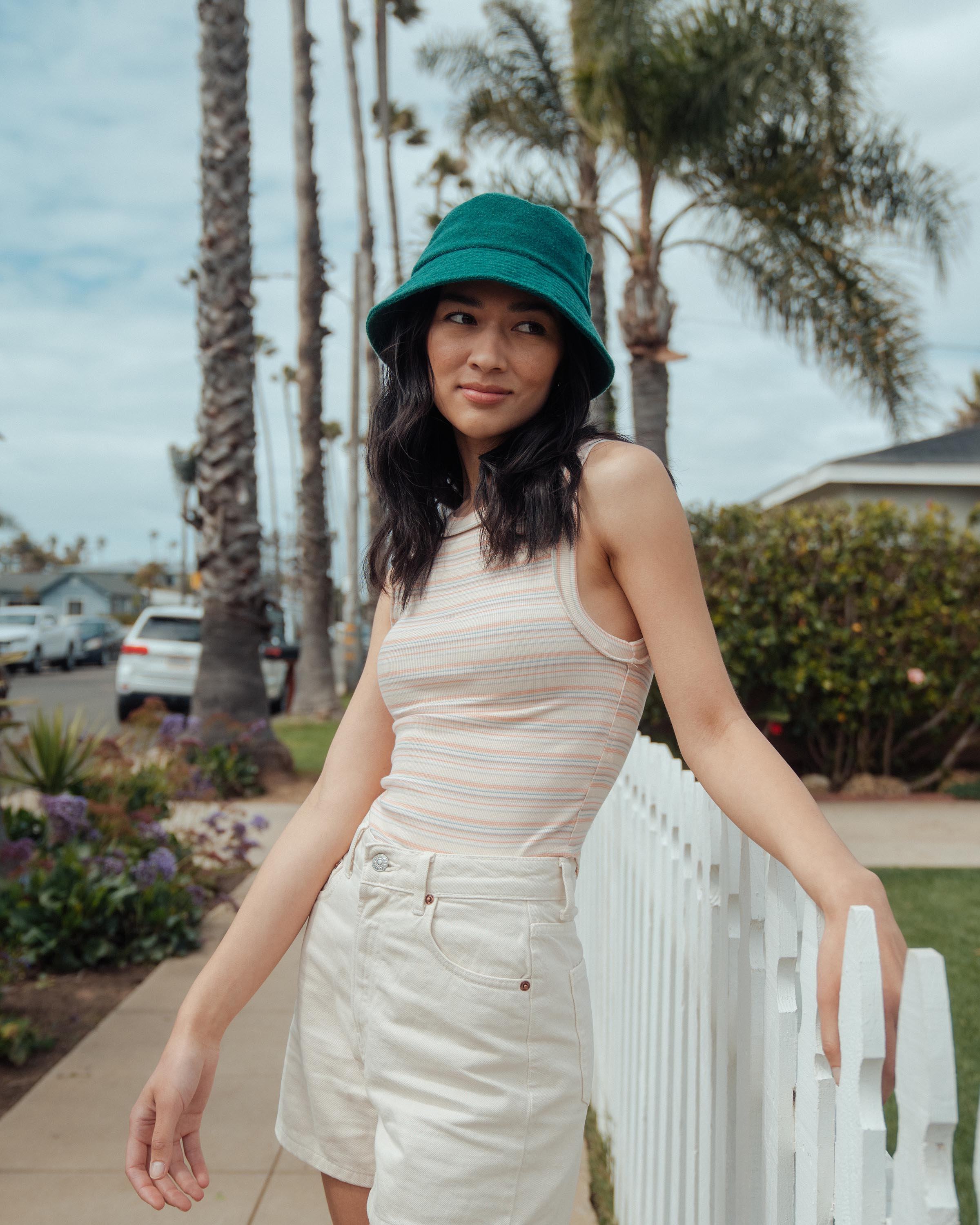 Hemlock female model looking right wearing Marina Terry Bucket Hat in Emerald