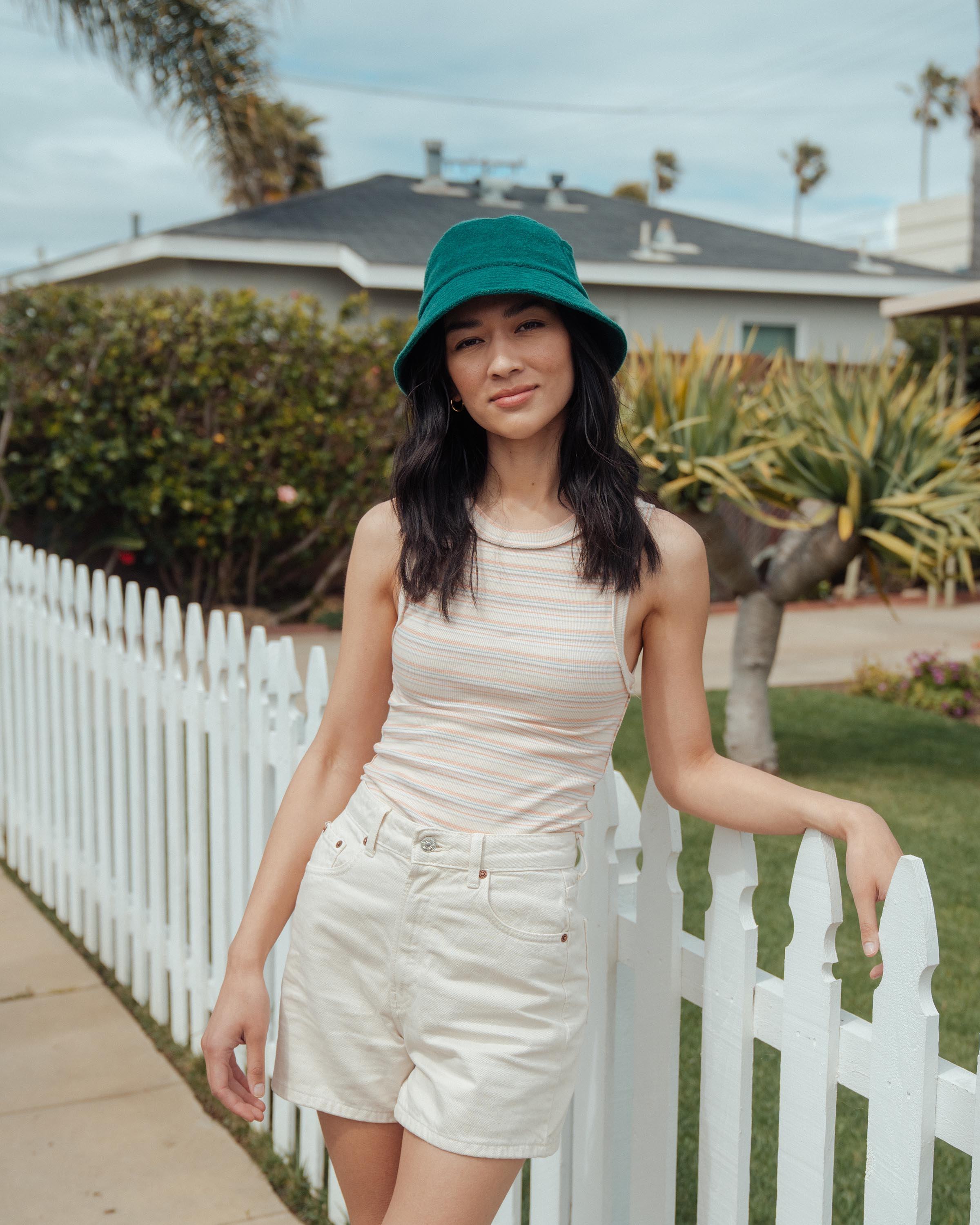 Hemlock female model looking straight wearing Marina Terry Bucket Hat in Emerald