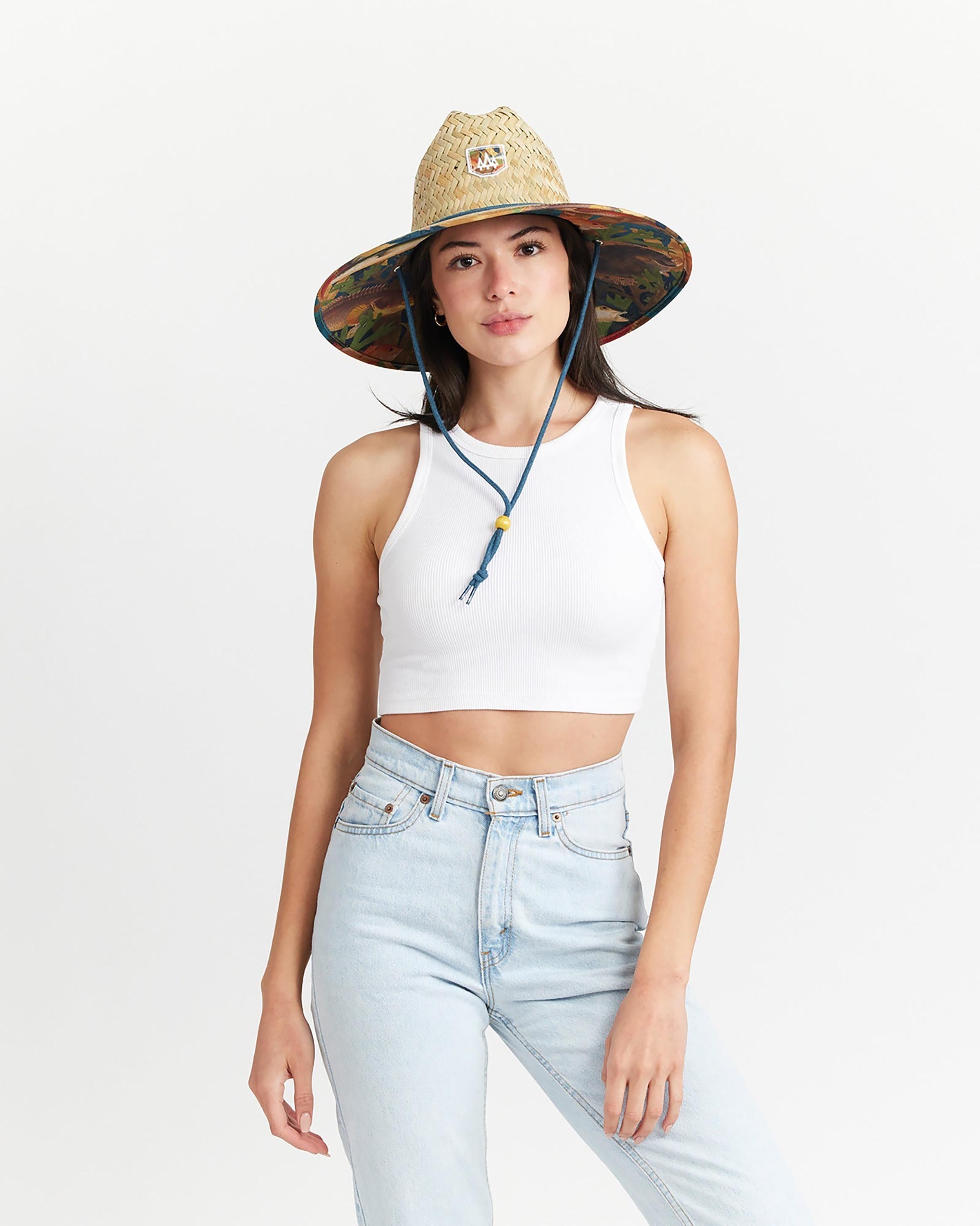 Hemlock female model looking straight wearing Mariner straw lifeguard hat with saltwater fish pattern